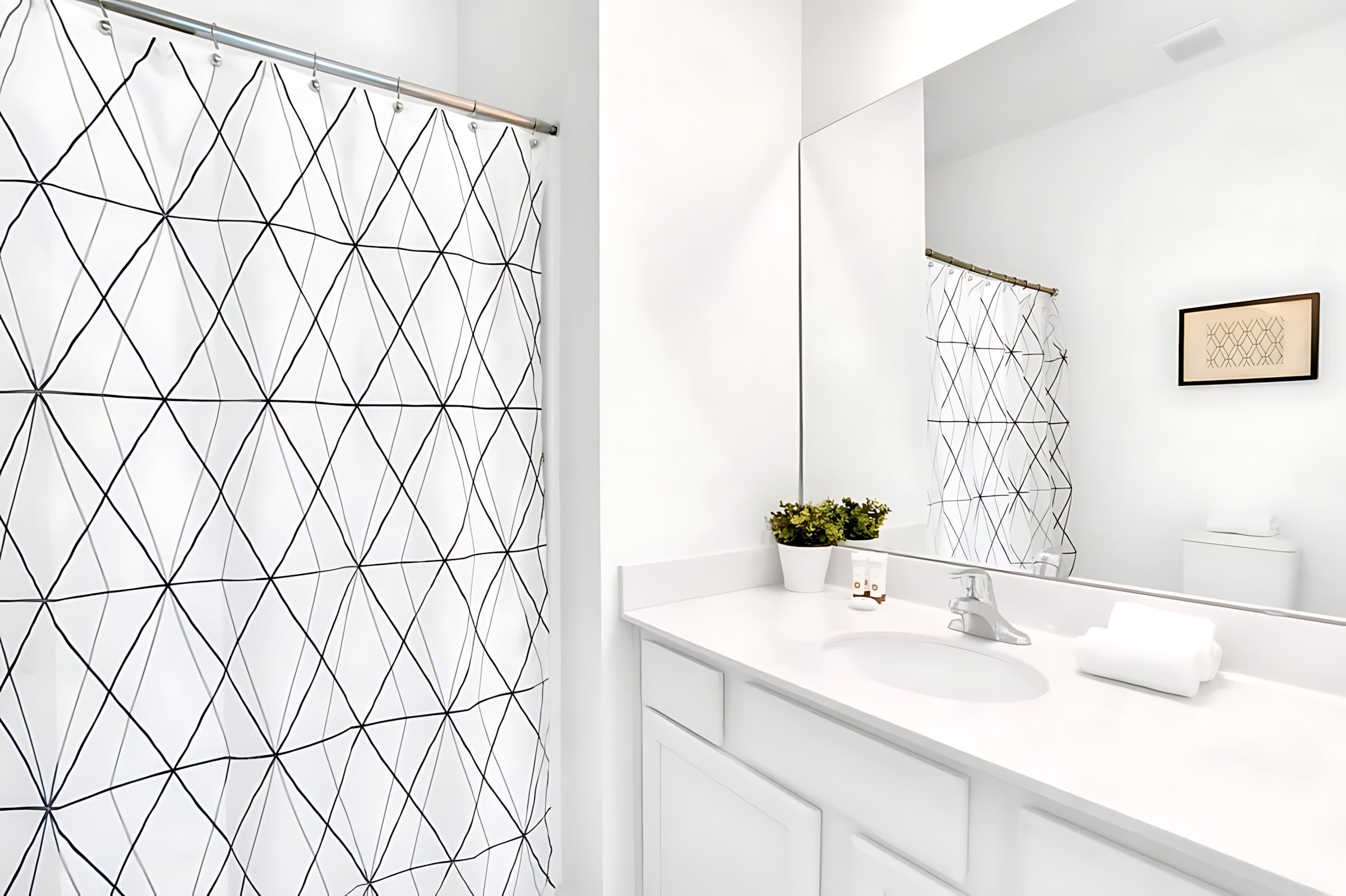 Bright Bathroom Featuring A Shower And Artistic Decor