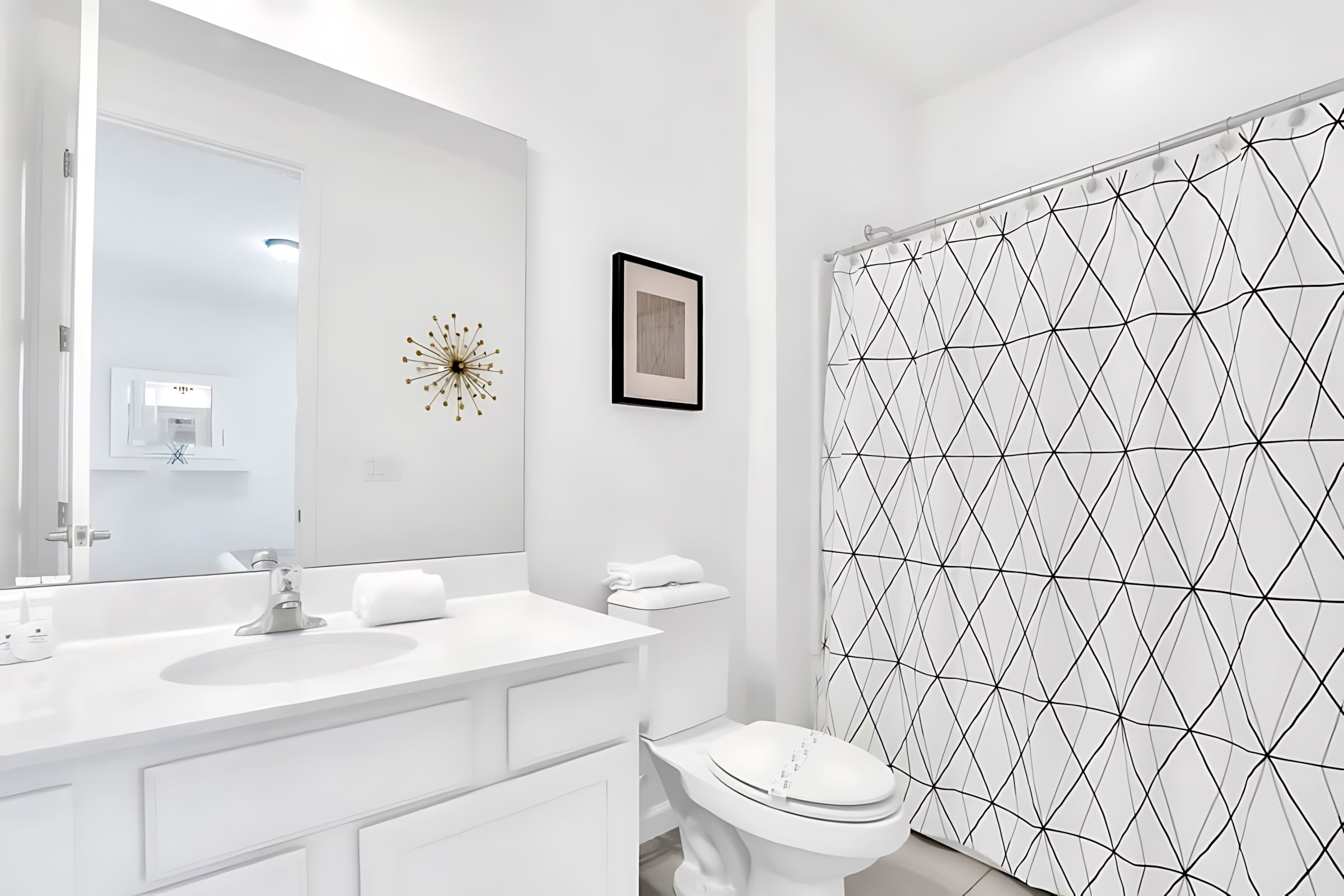 Bright Bathroom Featuring A Shower And Artistic Decor