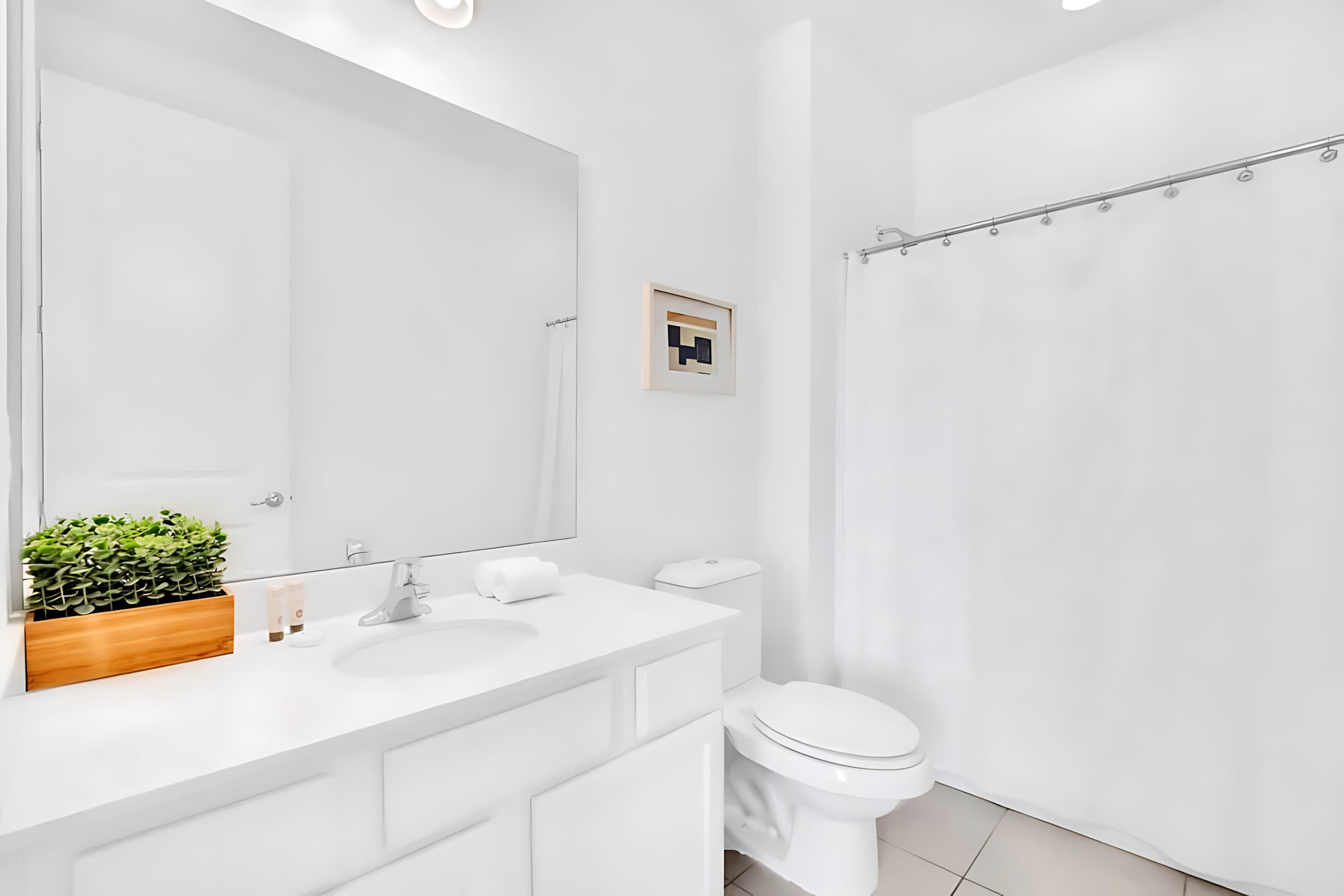 Bright Bathroom Featuring A Shower And Artistic Decor