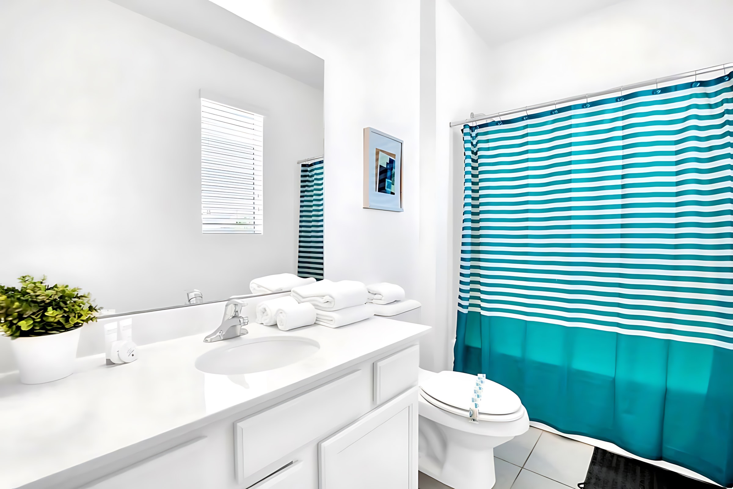 Bright Bathroom Featuring A Shower And Artistic Decor