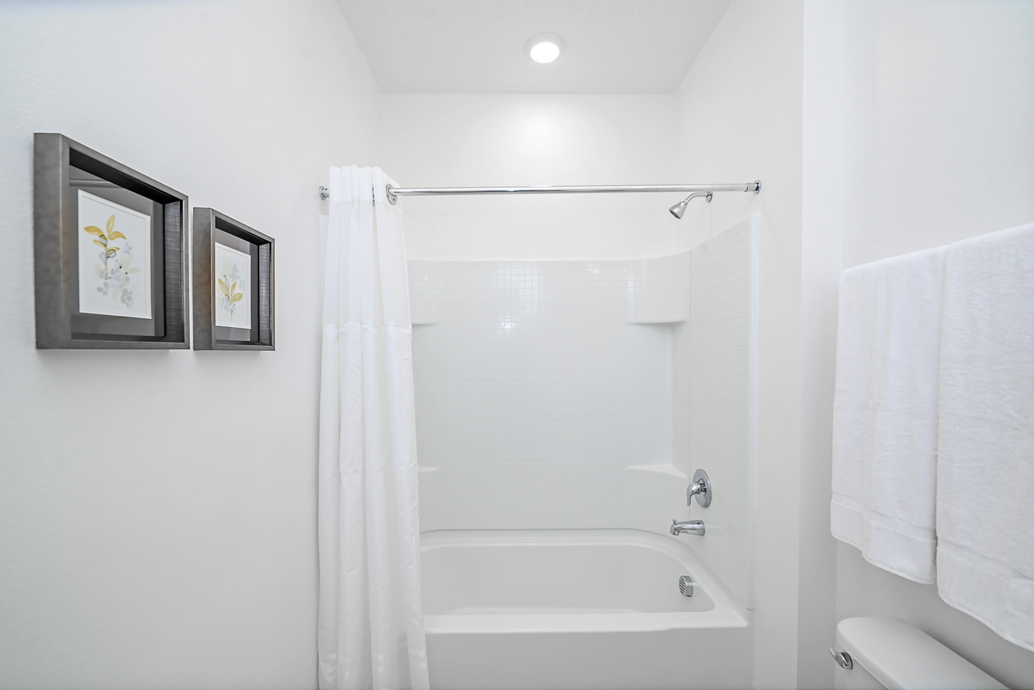 Bright Bathroom Featuring A Shower And Tub Combination With Clean Design