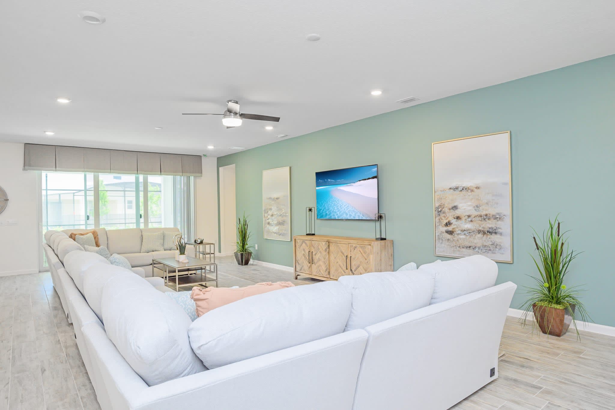 Spacious Living Room Featuring A Large Sectional And Smart TV