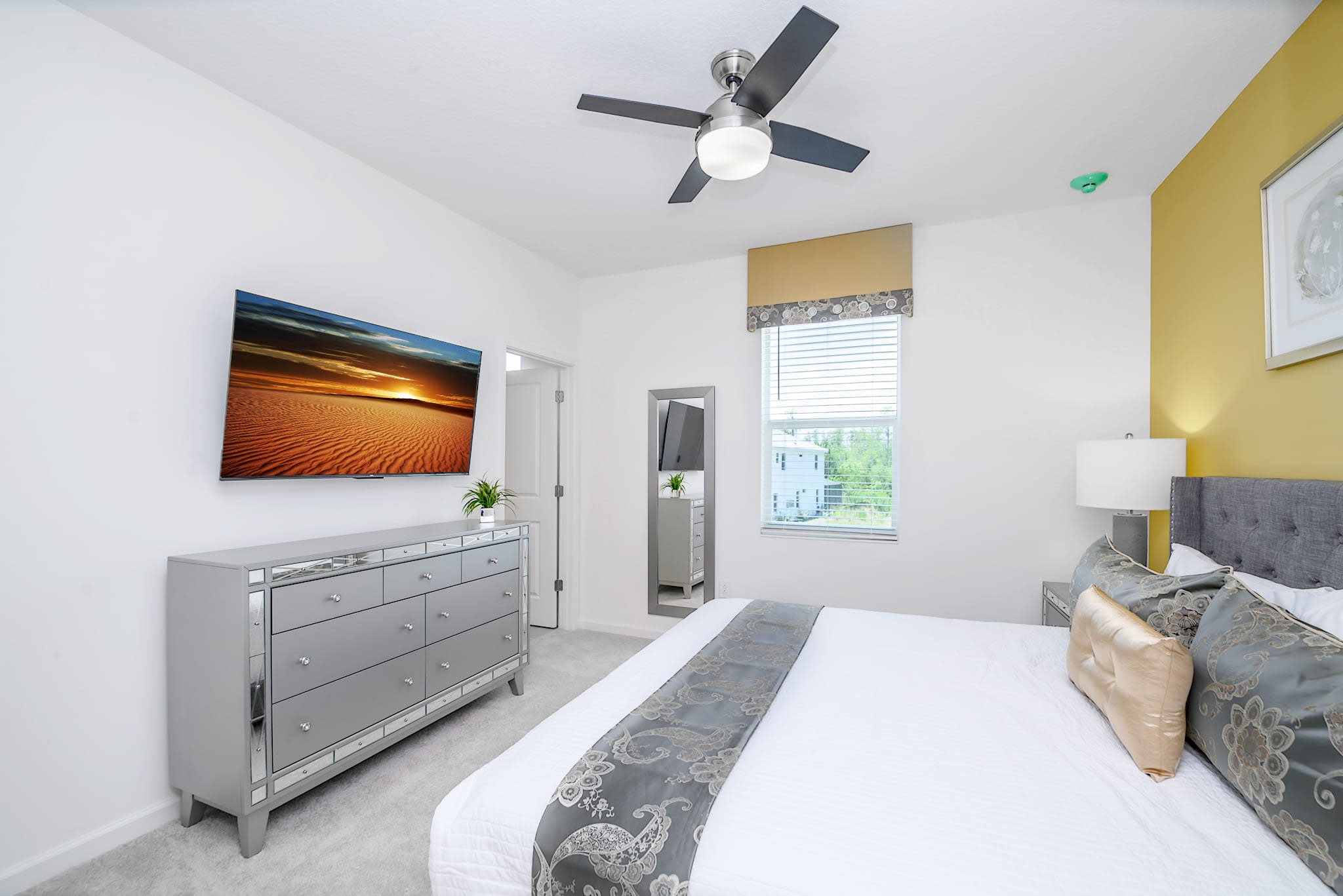 Spacious Bedroom Featuring A King-Sized Bed And Bold Yellow Accents