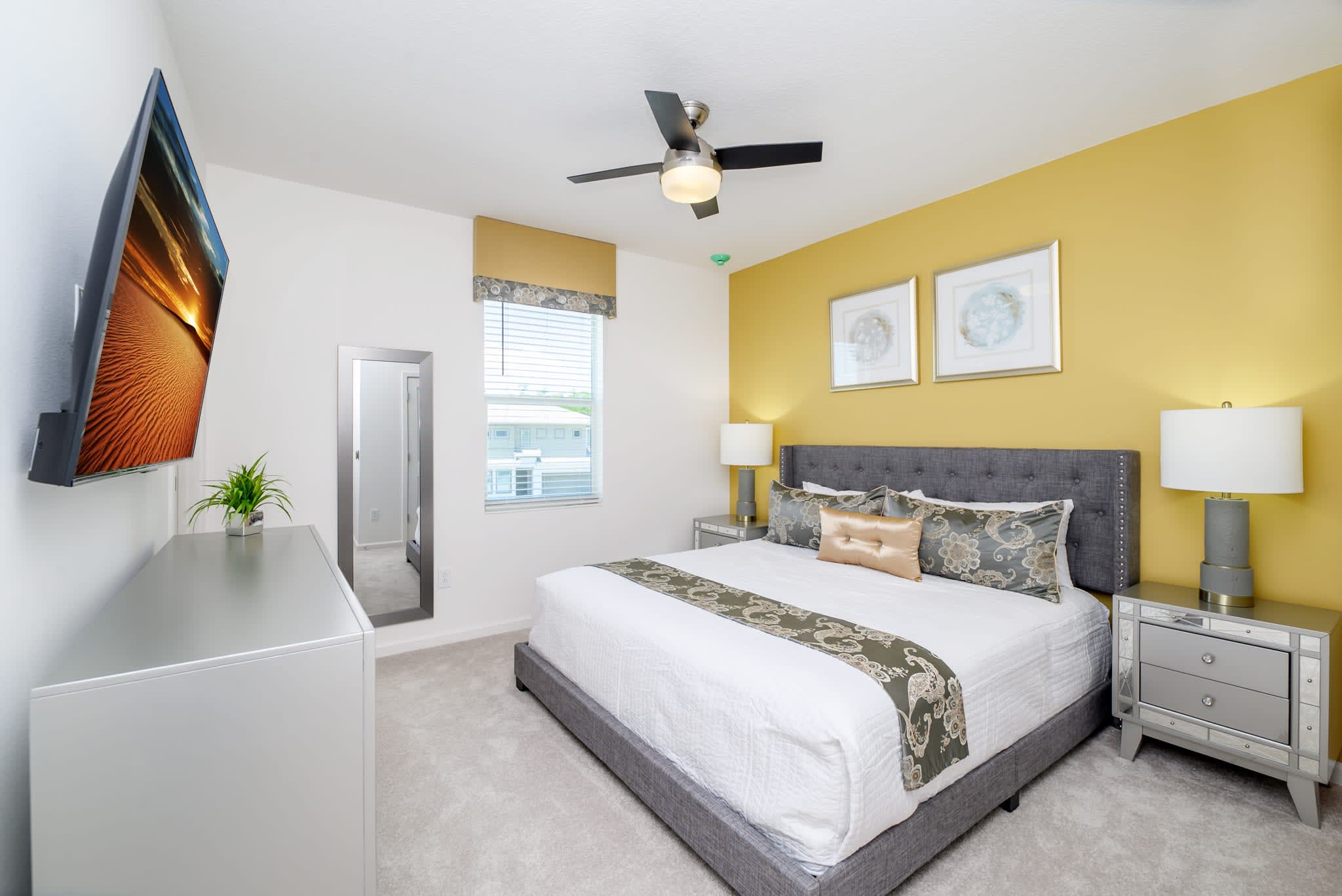 Spacious Bedroom Featuring A King-Sized Bed And Bold Yellow Accents