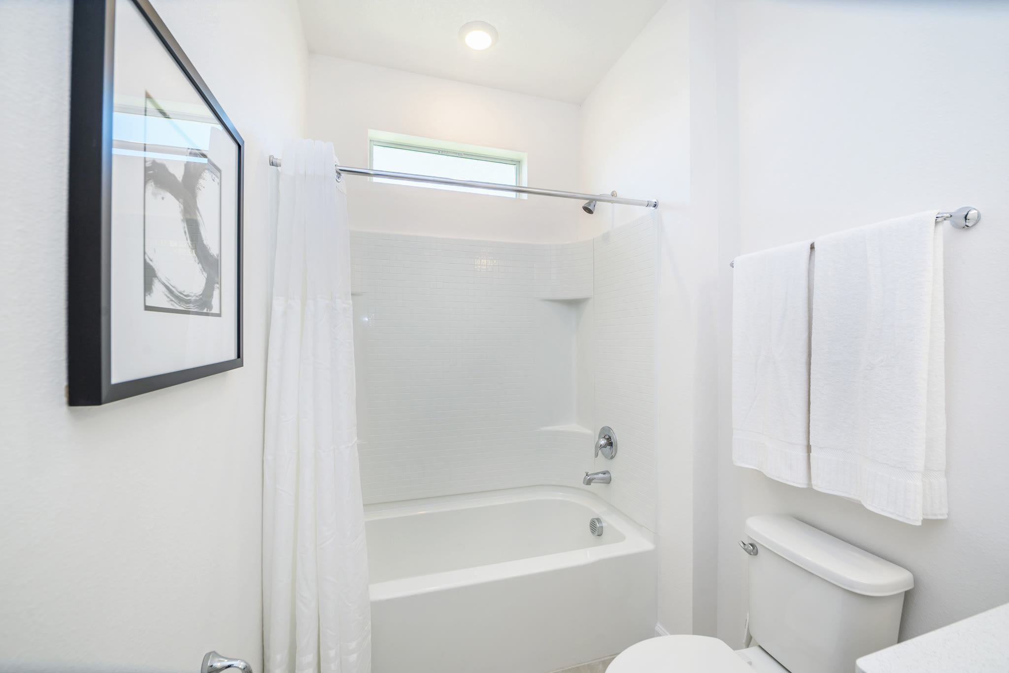 Bright Bathroom Featuring A Shower And Tub Combination With Clean Design