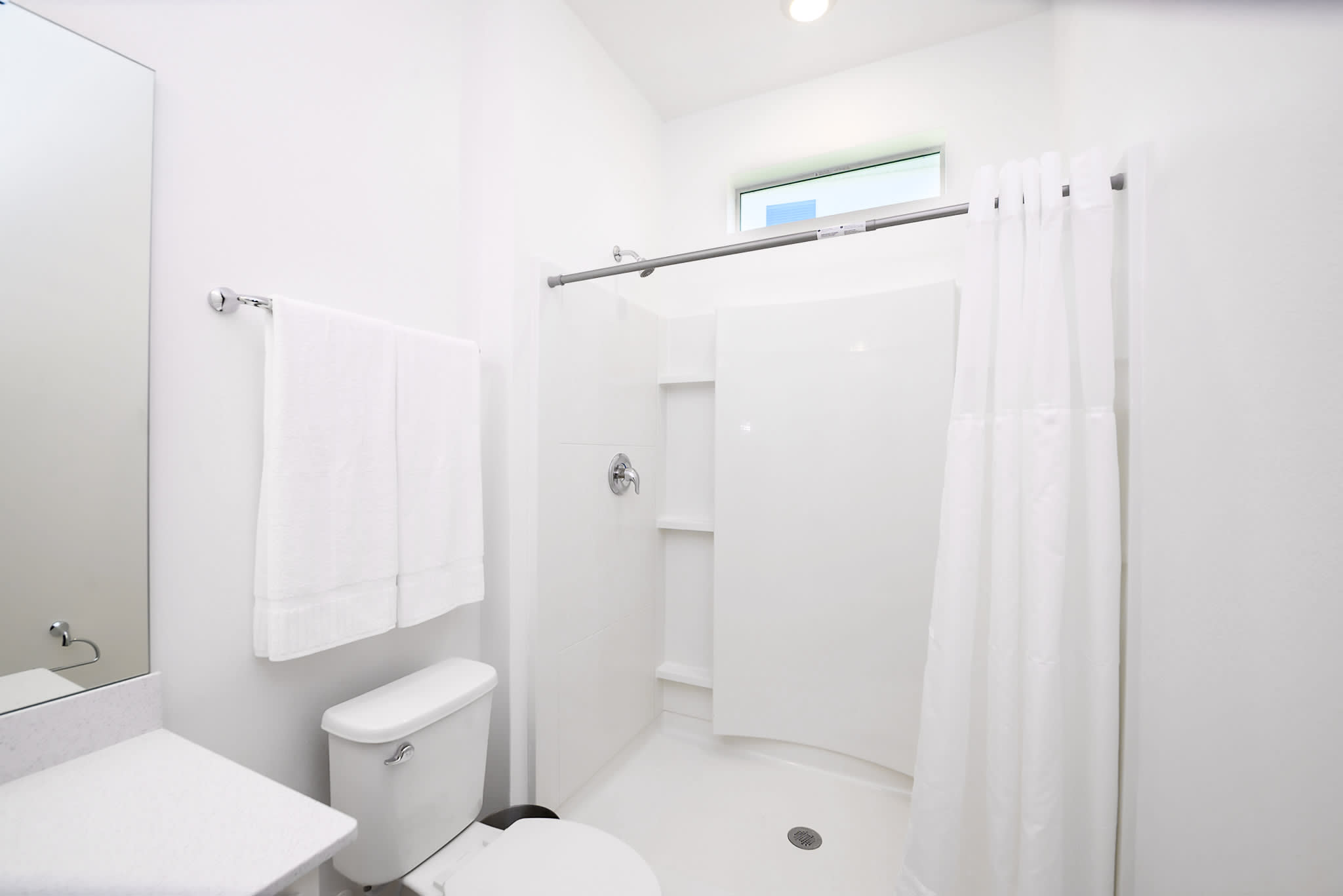 Bright Bathroom Featuring A Shower And Tub Combination With Clean Design