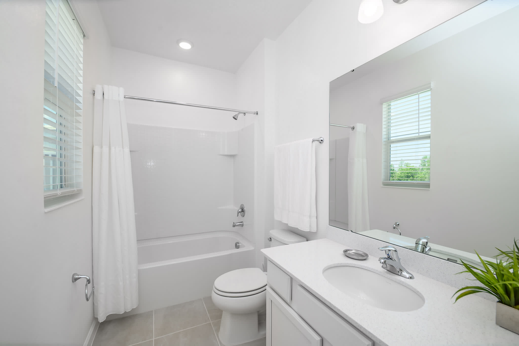 Bright Bathroom Featuring A Shower And Tub Combination With Clean Design