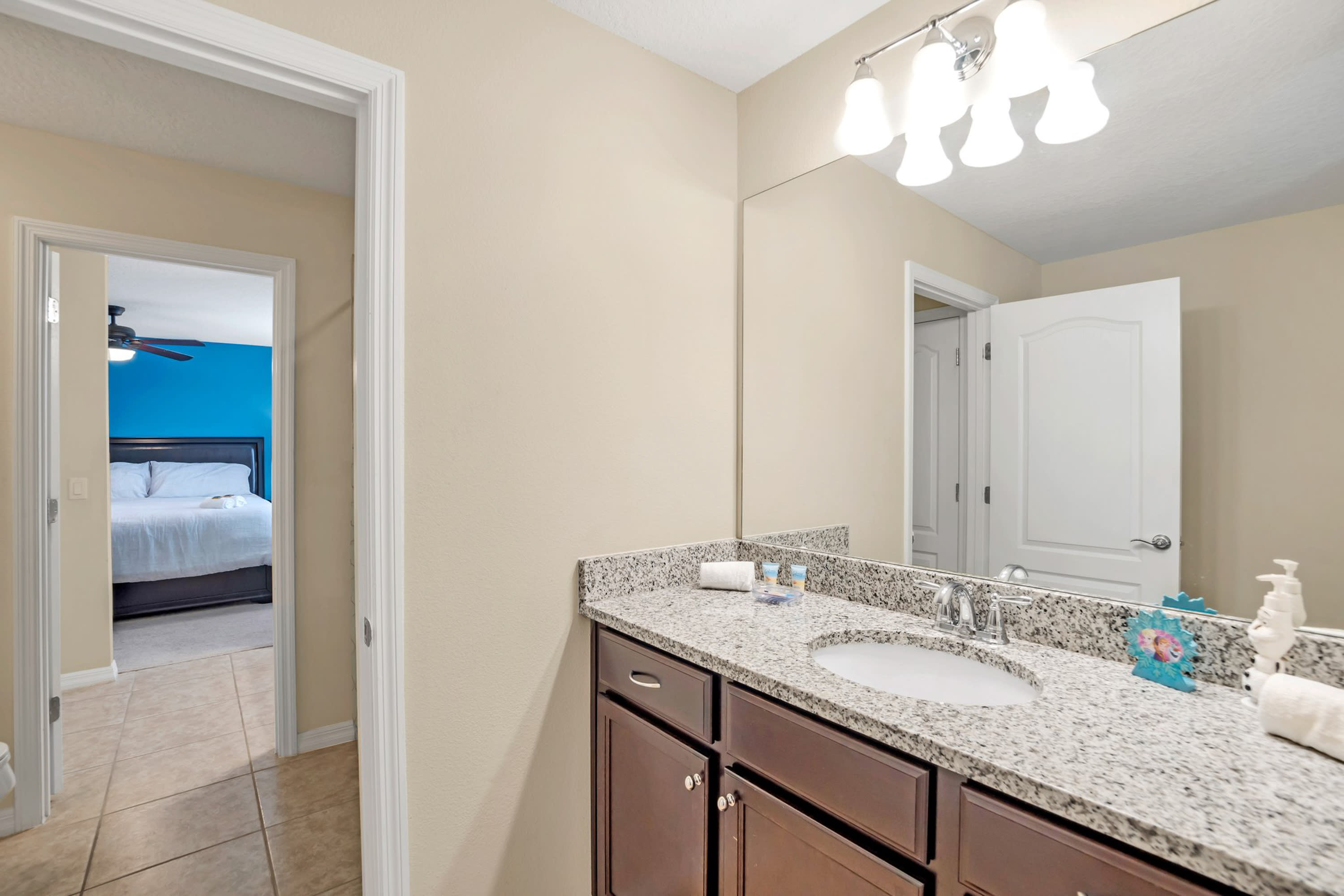 Elegant Bathroom Featuring Granite Finishes And Walk-In Shower