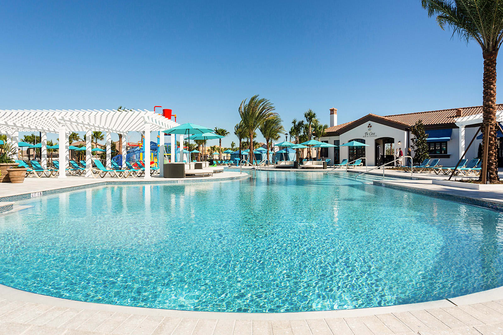 Luxurious Poolside Experience With Ample Seating And Shade Options