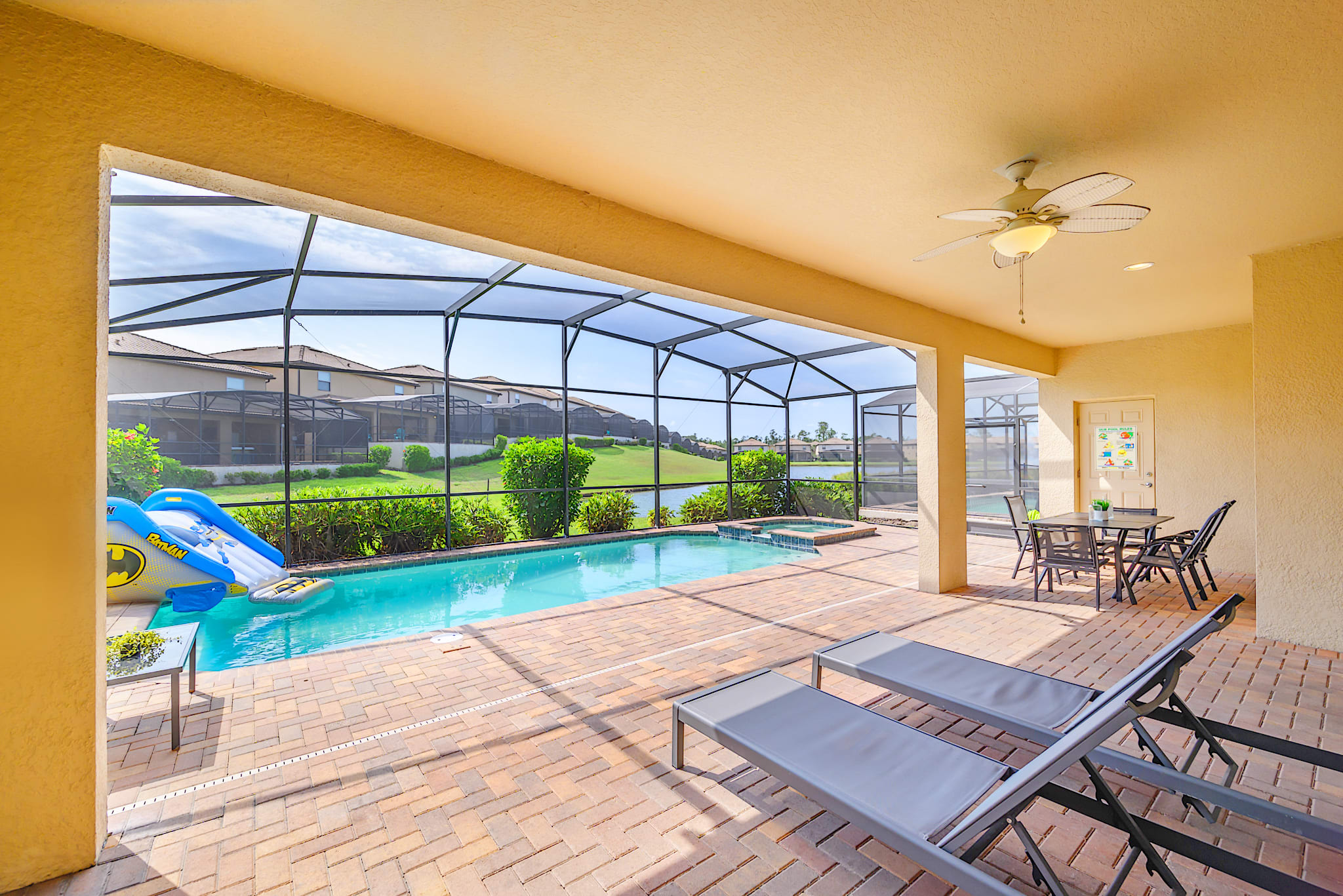 Private lake-facing screened-in back deck with sun loungers