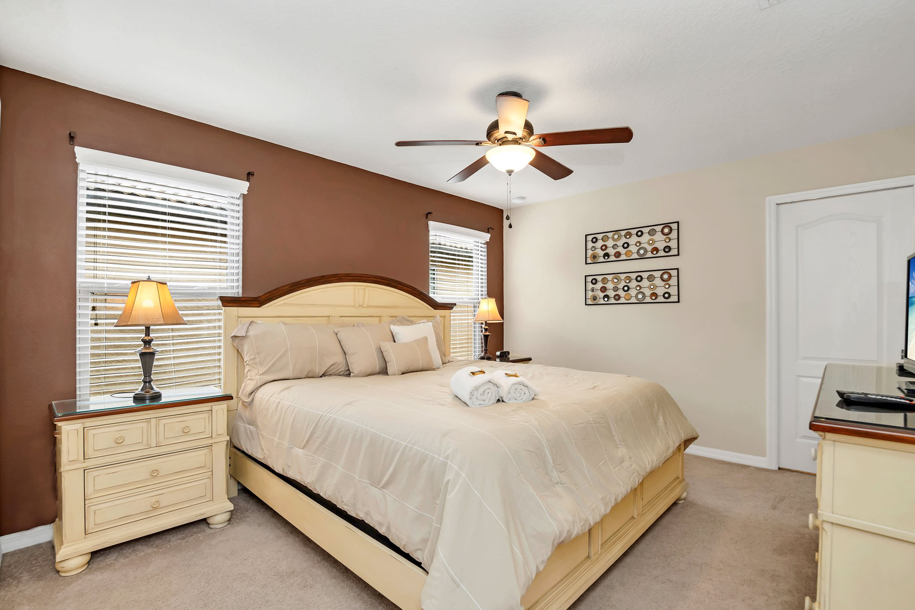 Stylish Bedroom Featuring A Queen Bed And Earthy Accents