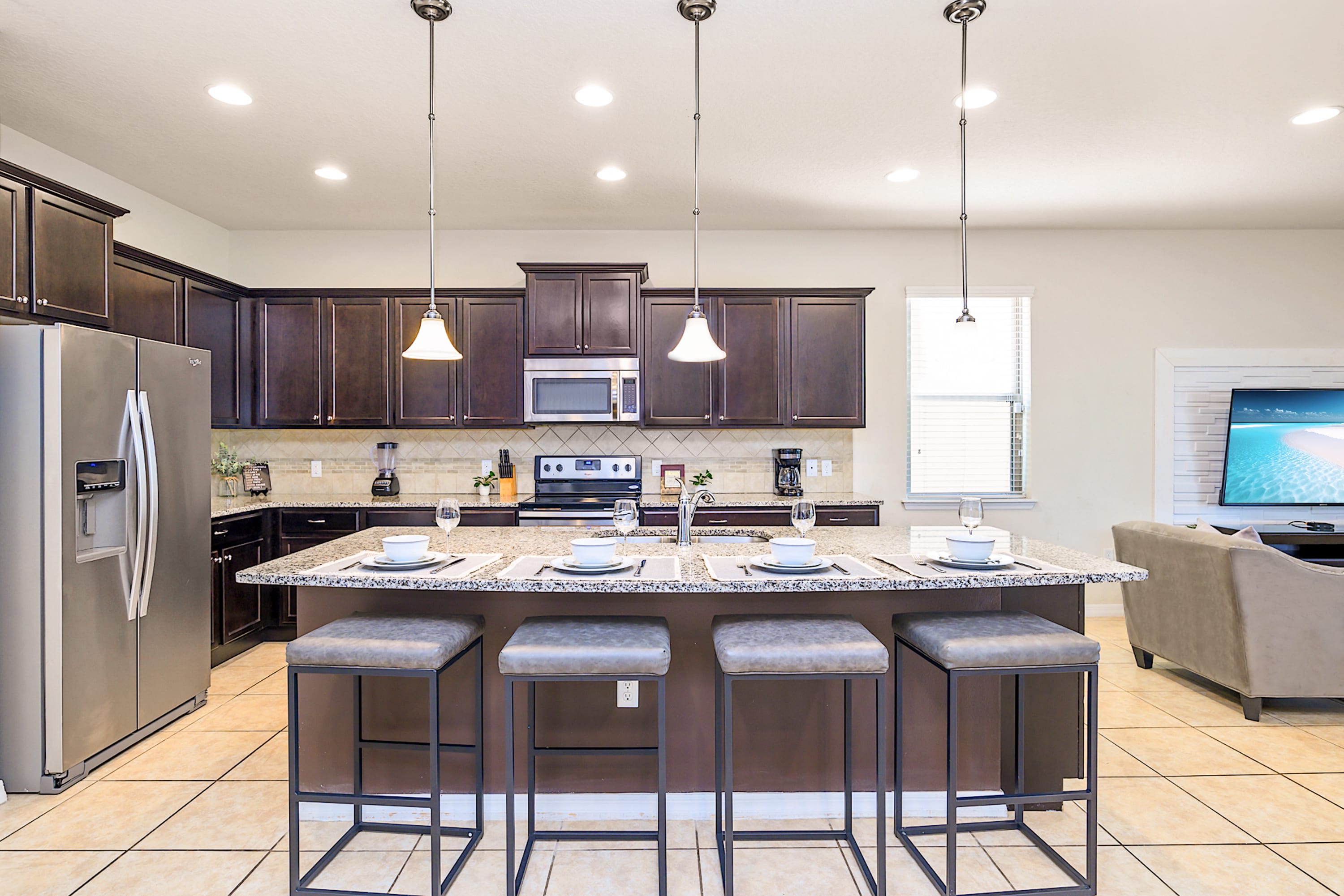 Fully Equipped Kitchen With High-End Appliances And Seating For Four
