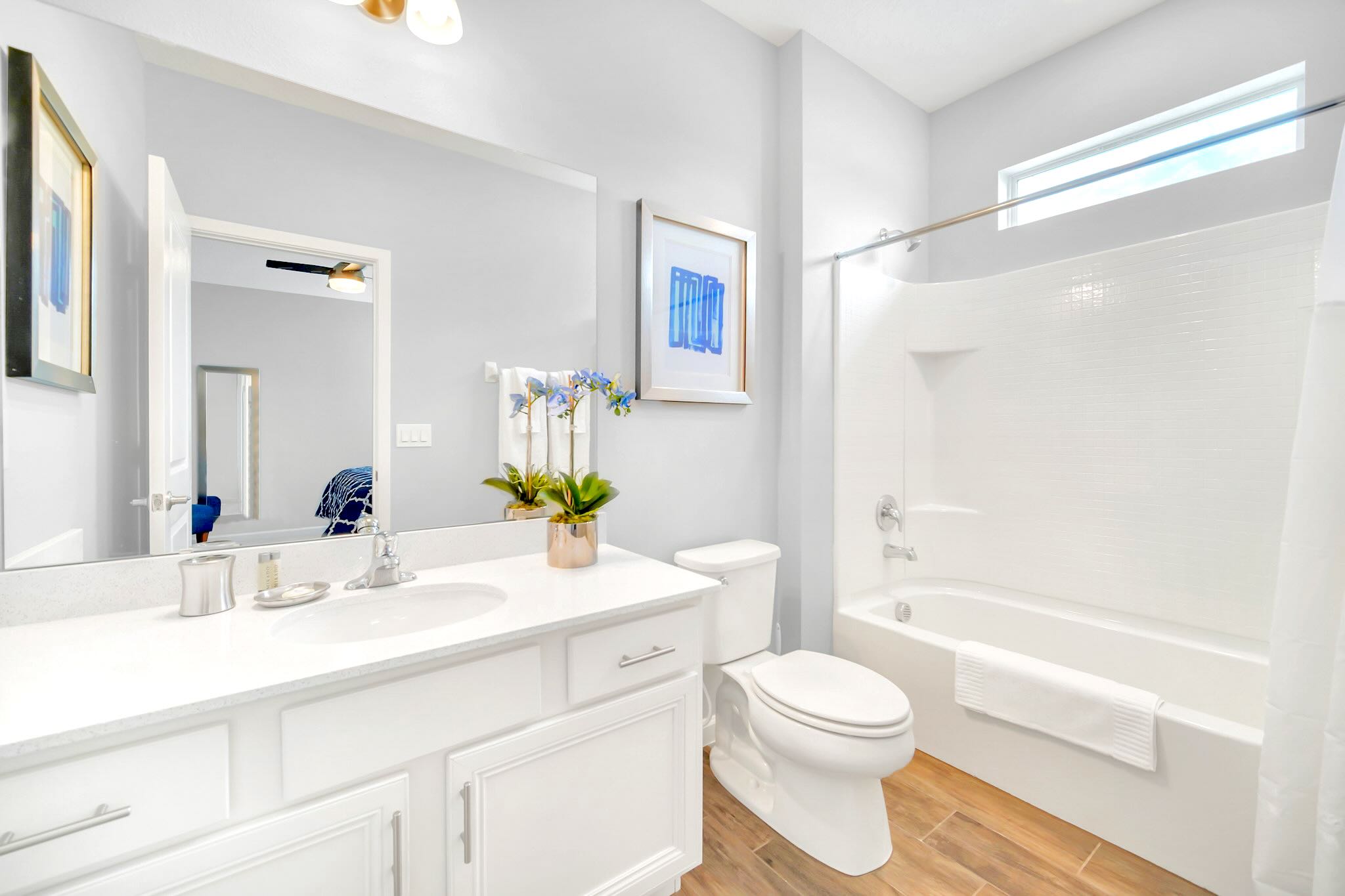 Bright And Functional Bathroom With A Shower And Vanity Space