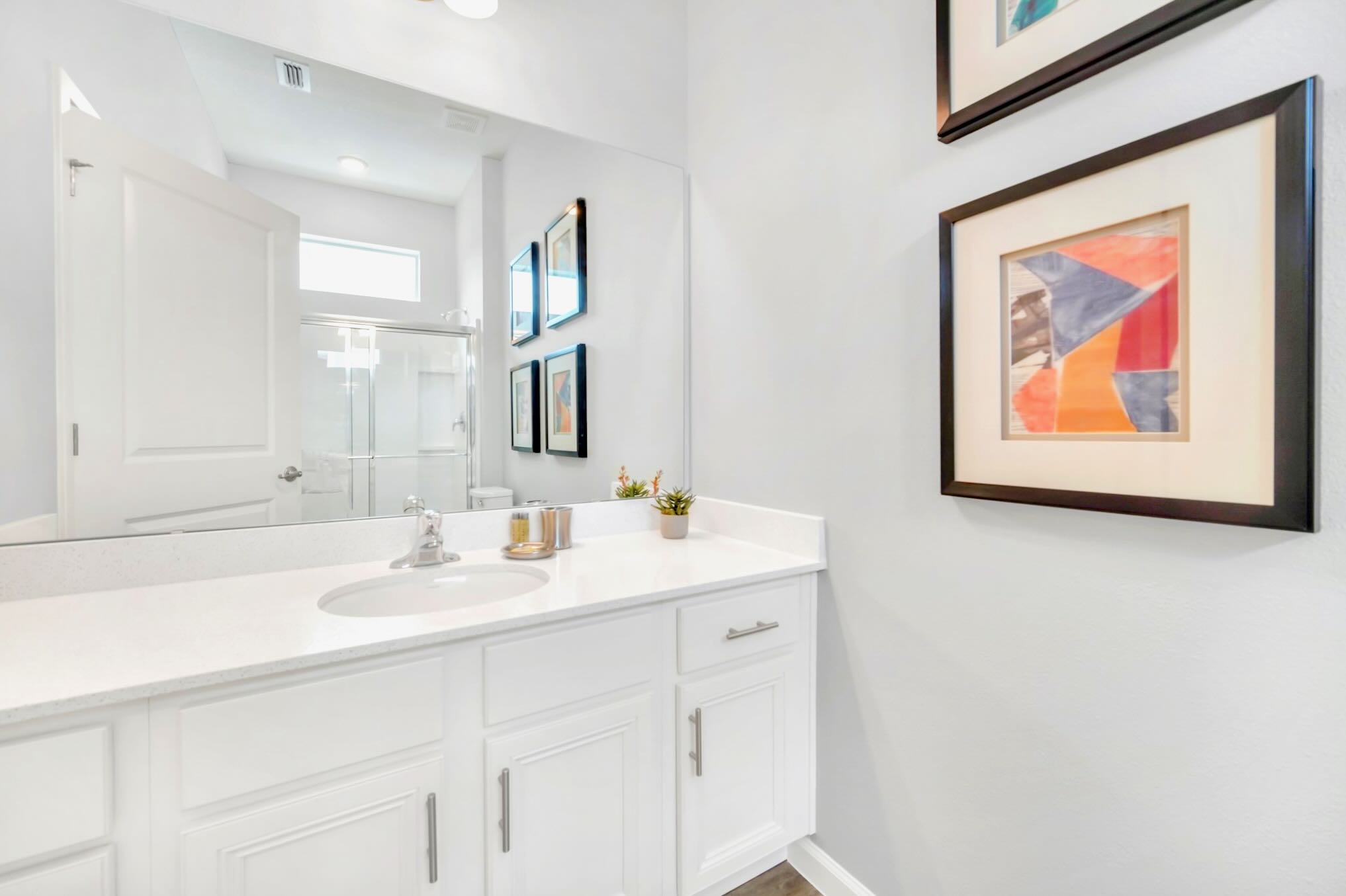 Bright And Functional Bathroom With A Shower And Vanity Space