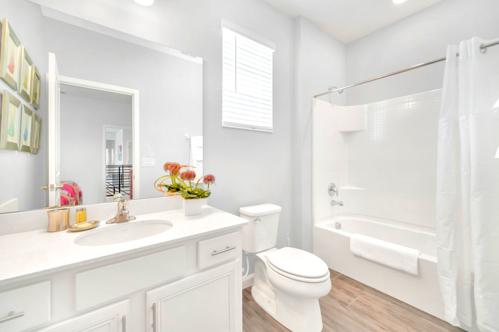 Bright And Functional Bathroom With A Shower And Vanity Space