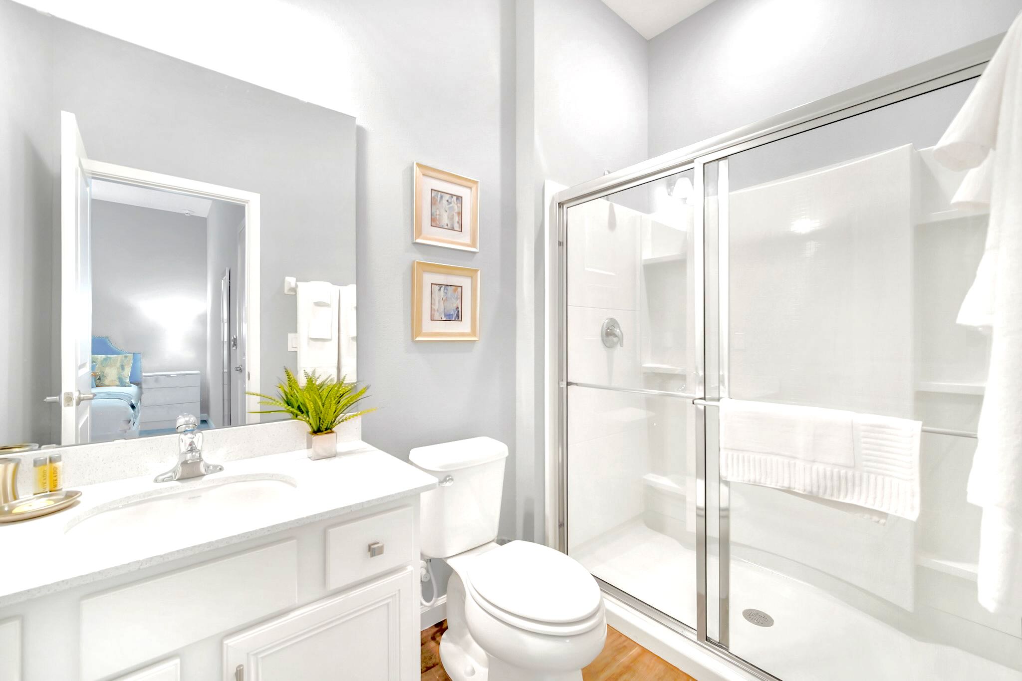 Bright And Functional Bathroom With A Shower And Vanity Space