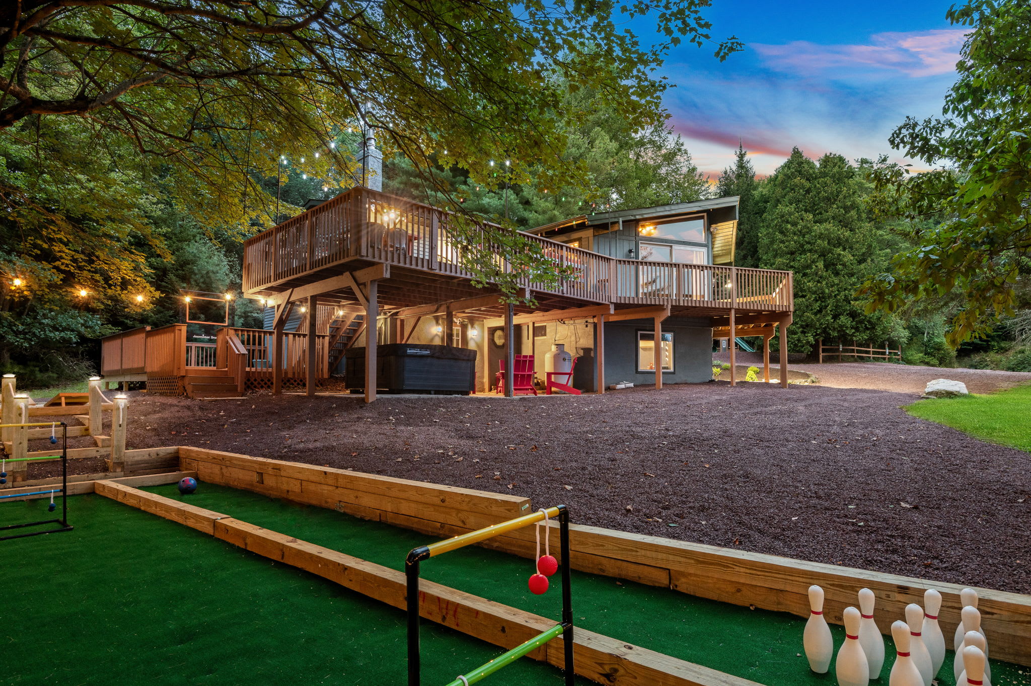 A spacious deck, a bubbling hot tub, and a fun outdoor game area make this home the perfect mix of excitement and tranquility.