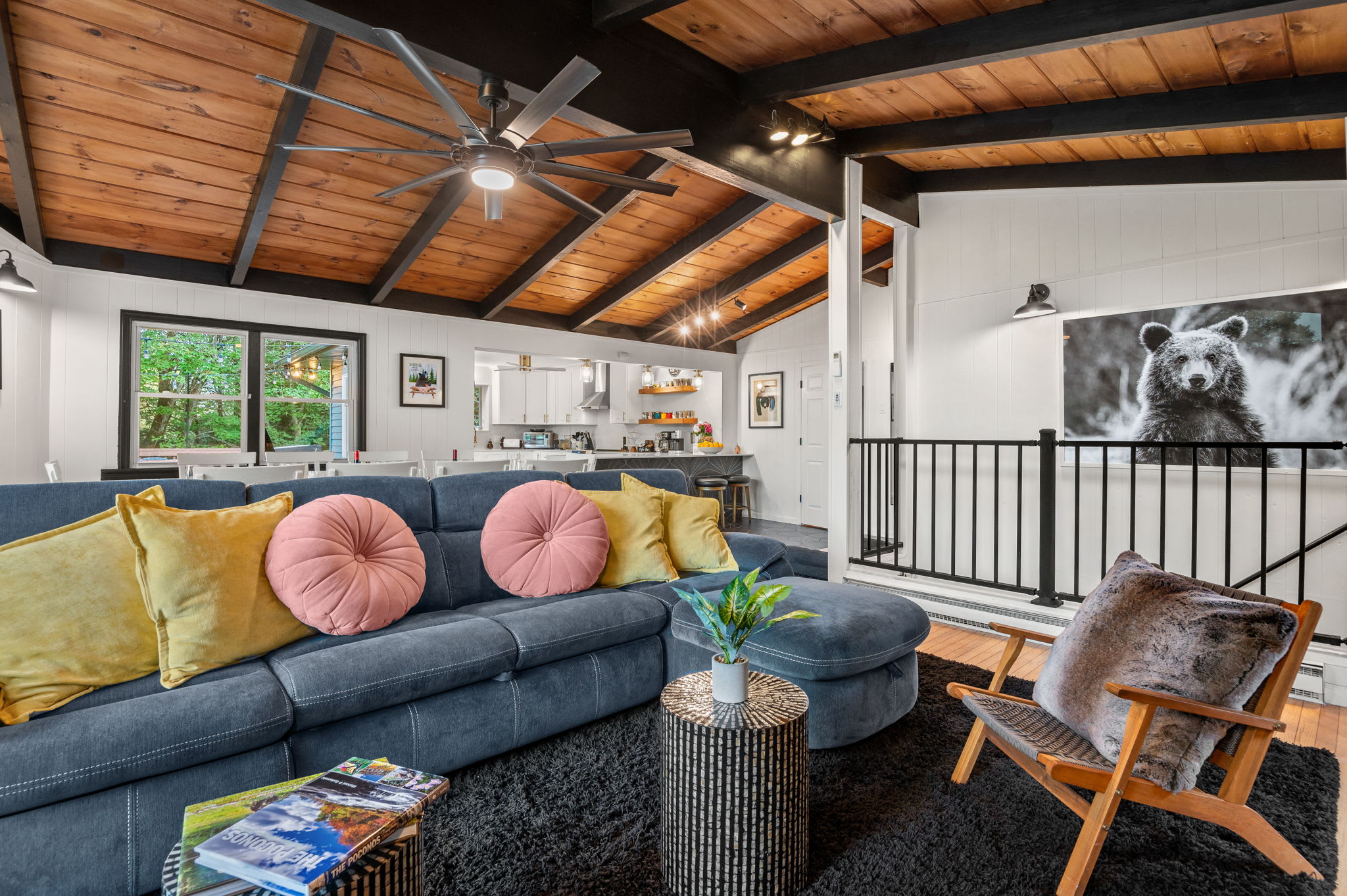 With exposed wood beams, plush seating, and stylish decor, this inviting living space is perfect for unwinding in comfort.