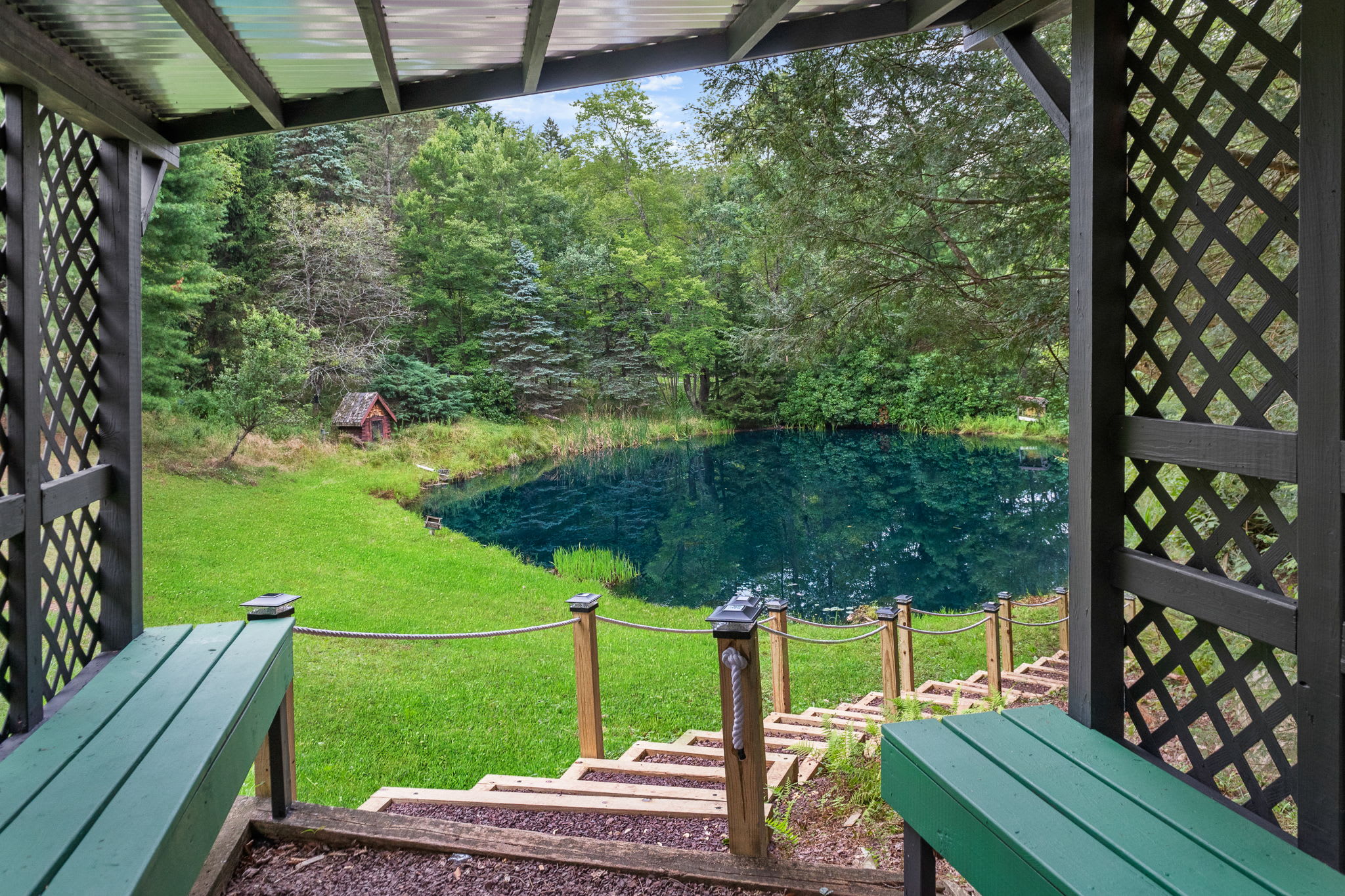 Enjoy the best seat in the house! This charming gazebo provides a shaded retreat with stunning pond views, perfect for sipping your morning coffee.