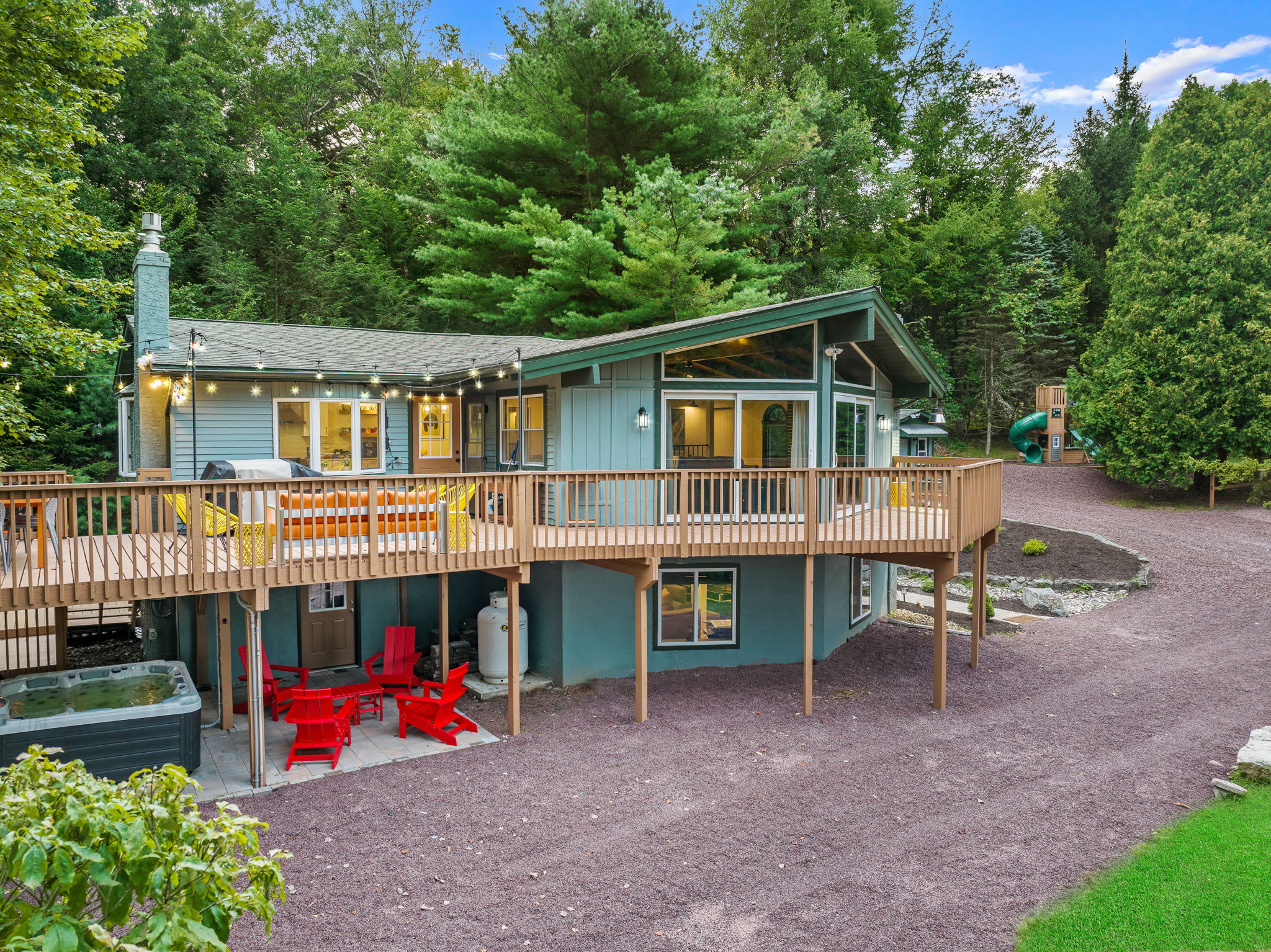 This stunning home features multiple decks, an outdoor dining area, and a cozy patio, plenty of space for everyone to enjoy.