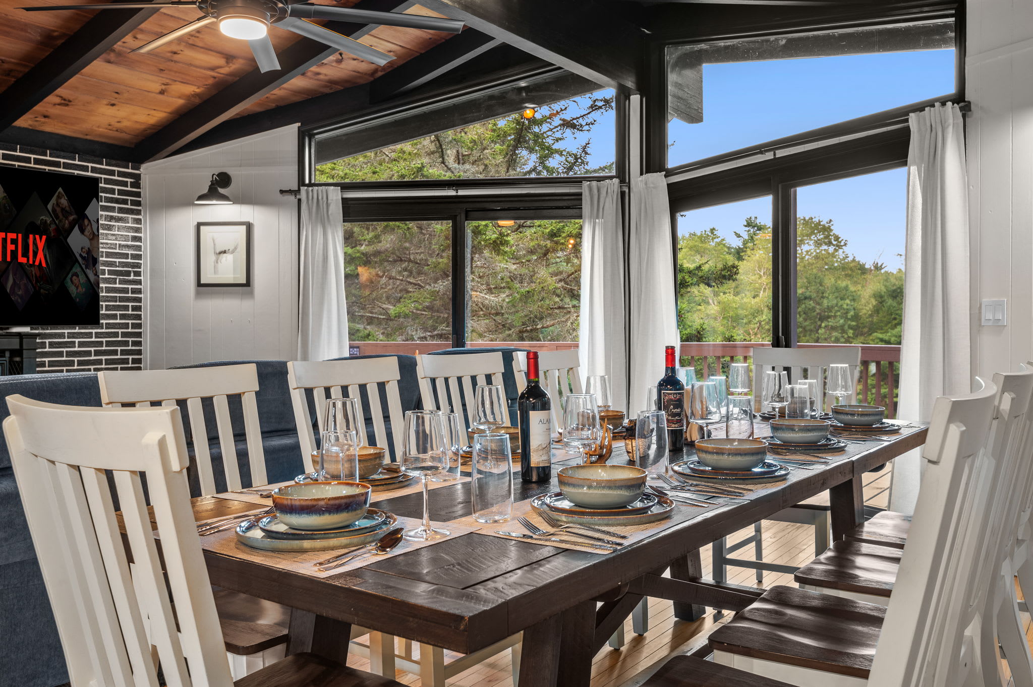 Enjoy a beautifully set dining table surrounded by floor-to-ceiling windows, making every meal feel like a special occasion.