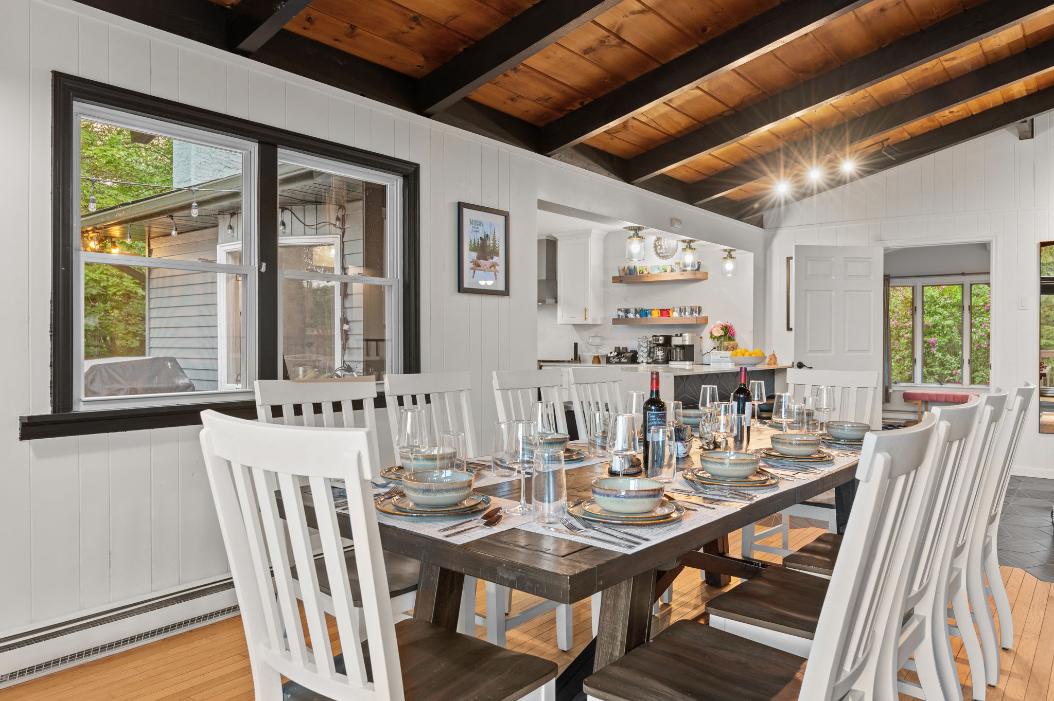 This spacious dining area with high ceilings and warm lighting is the perfect place to bring everyone together for memorable meals.