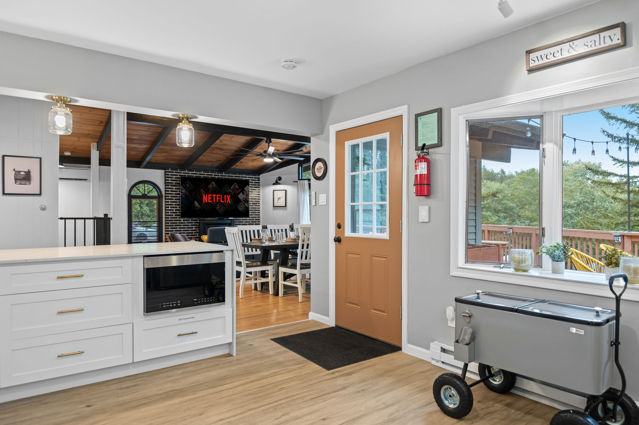 Step into a warm and inviting kitchen space with modern touches, a charming entryway, and beautiful natural light.
