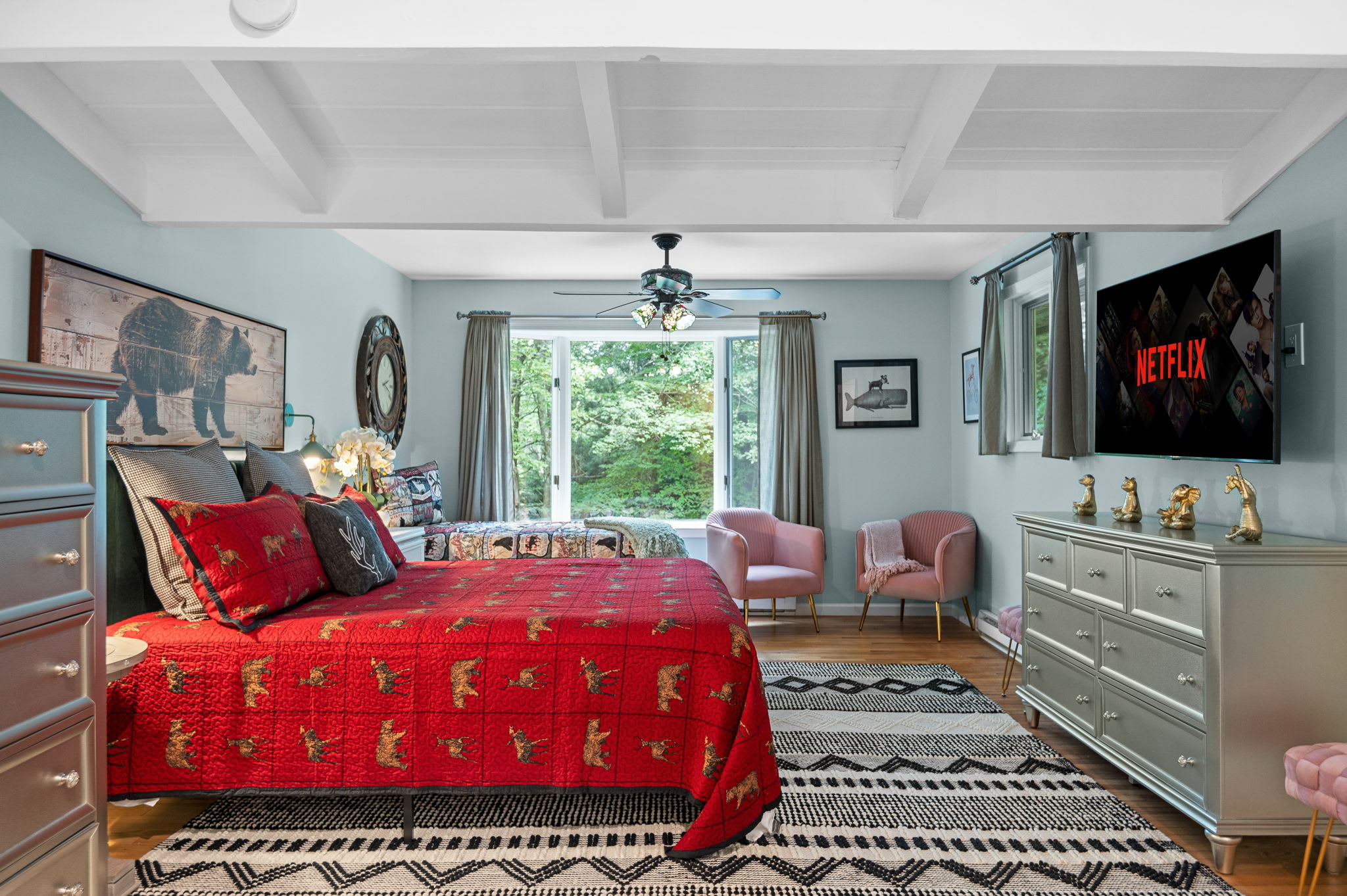This beautifully designed bedroom blends cozy cabin vibes with bright, airy elegance, complete with a plush queen bed.