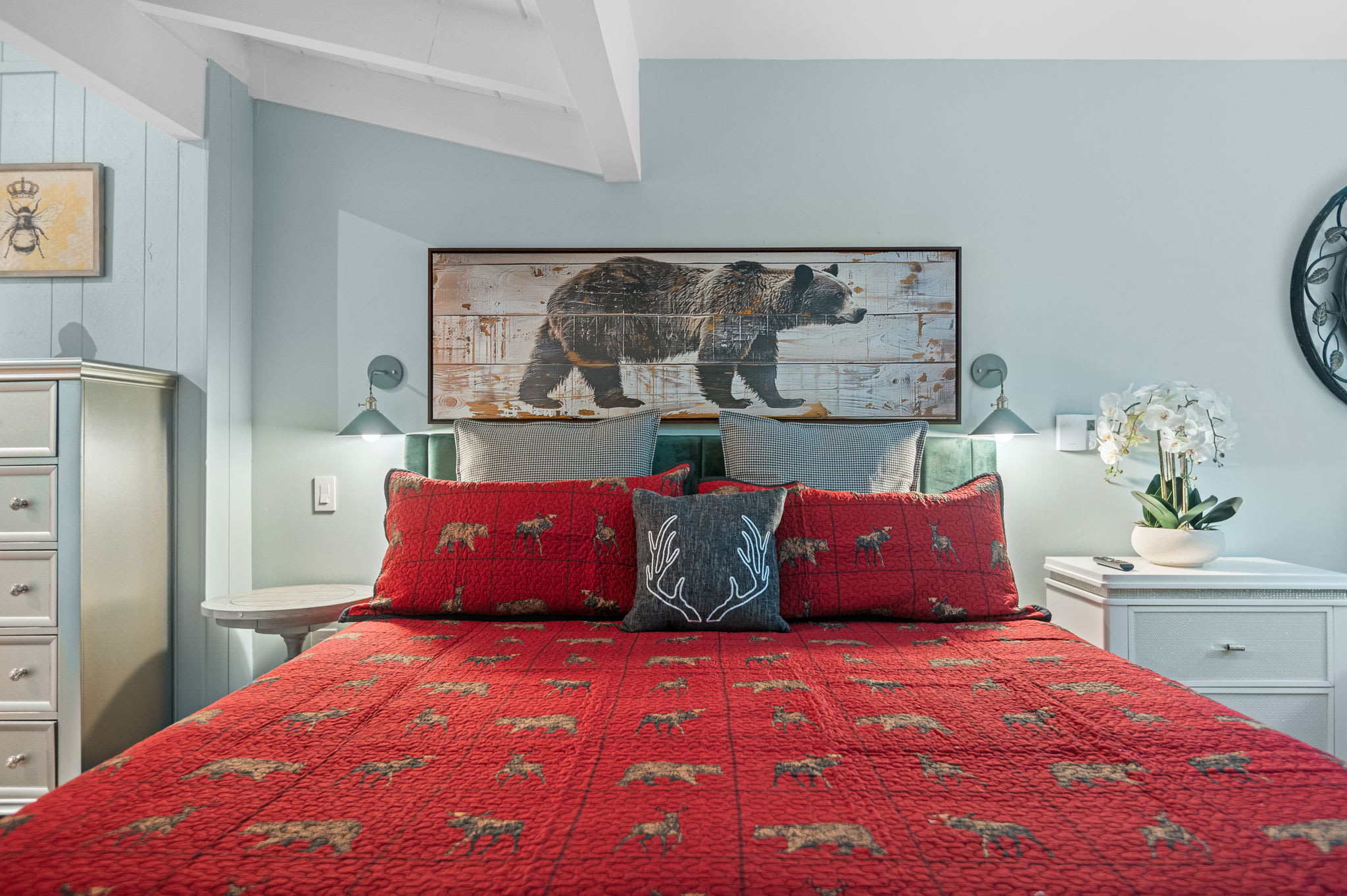 A comfy, lodge-inspired bed with soft, inviting linens and warm accents—your perfect escape after a day of adventure.