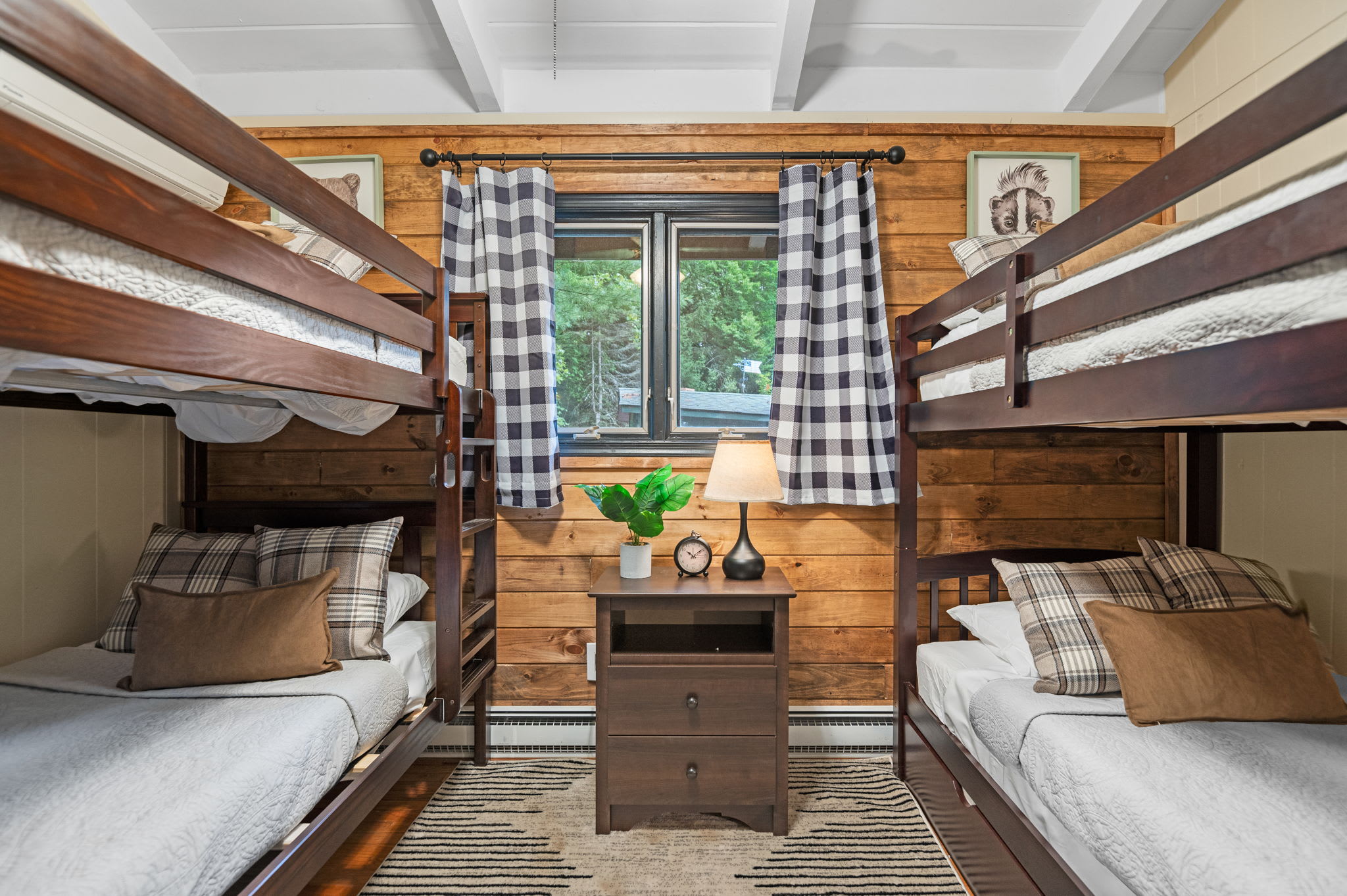 This rustic yet modern bunk room is perfect for kids or friends, offering a cozy cabin feel with plenty of space for restful nights.