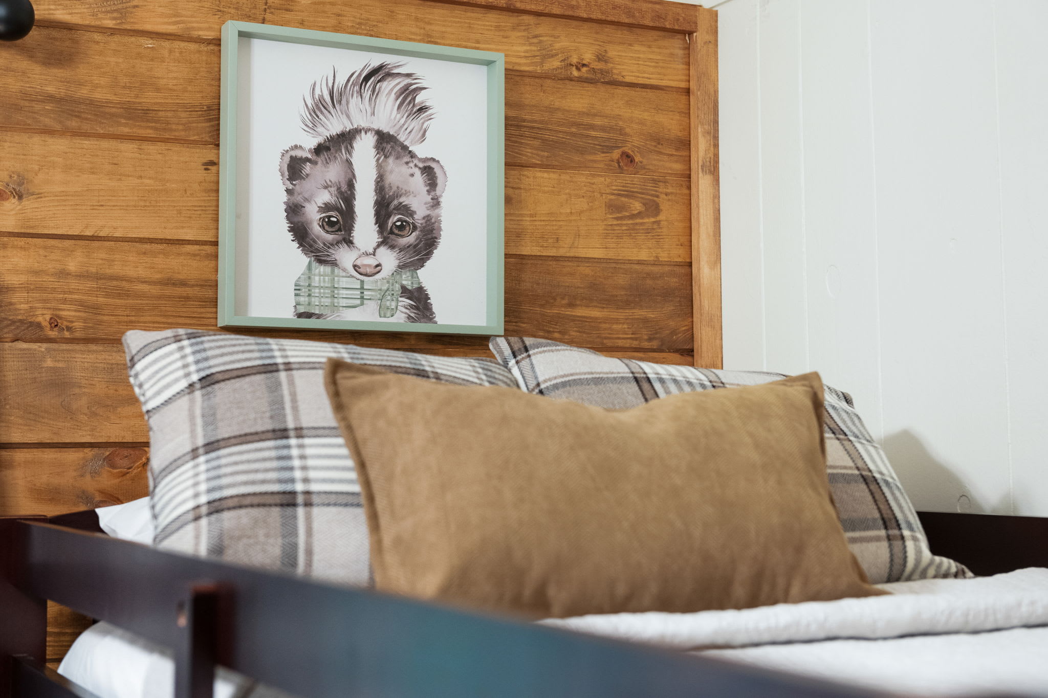 Every bed is thoughtfully designed with soft linens and charming décor, including this adorable woodland-inspired artwork.