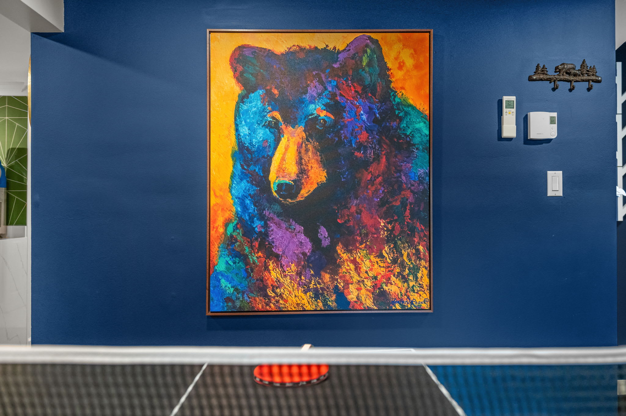 This stunning, colorful bear artwork adds a vibrant touch to the game room, setting the mood for a fun and adventurous stay.