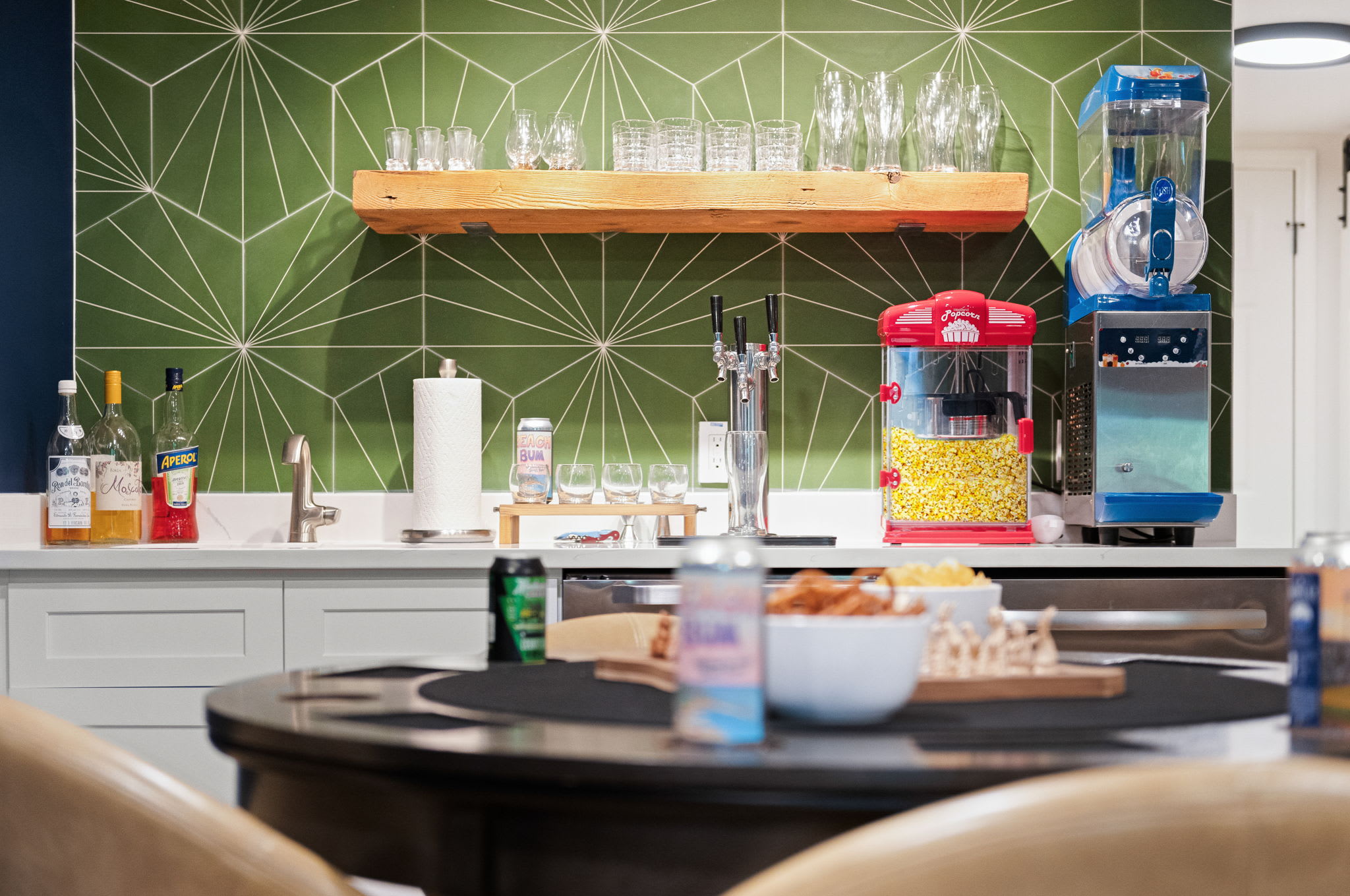 A stylish kitchenette with a popcorn machine, drink station, and sleek modern touches, perfect for entertaining.