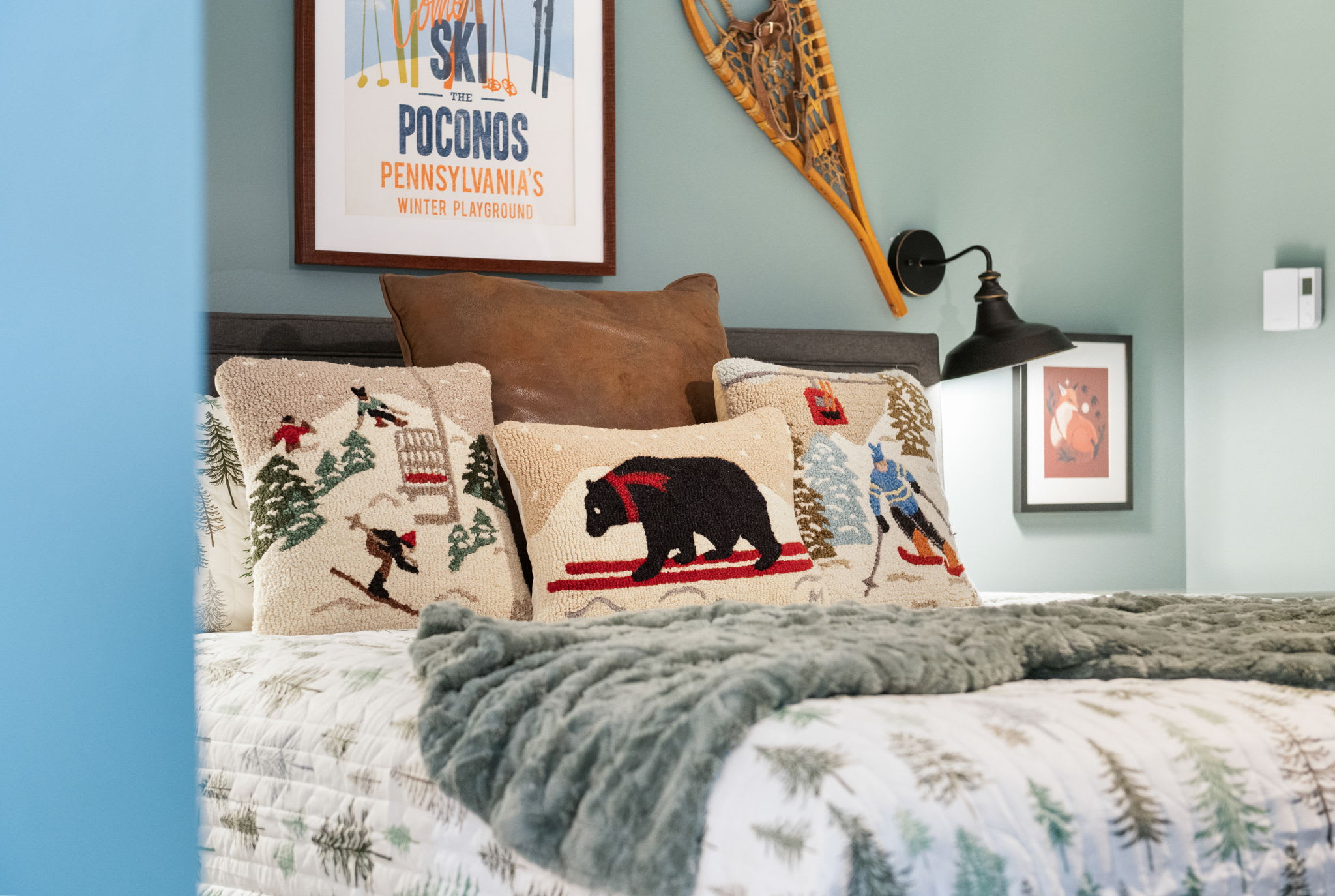 This charming bedroom features rustic ski-lodge decor, warm earth tones, and soft linens for a restful mountain retreat.