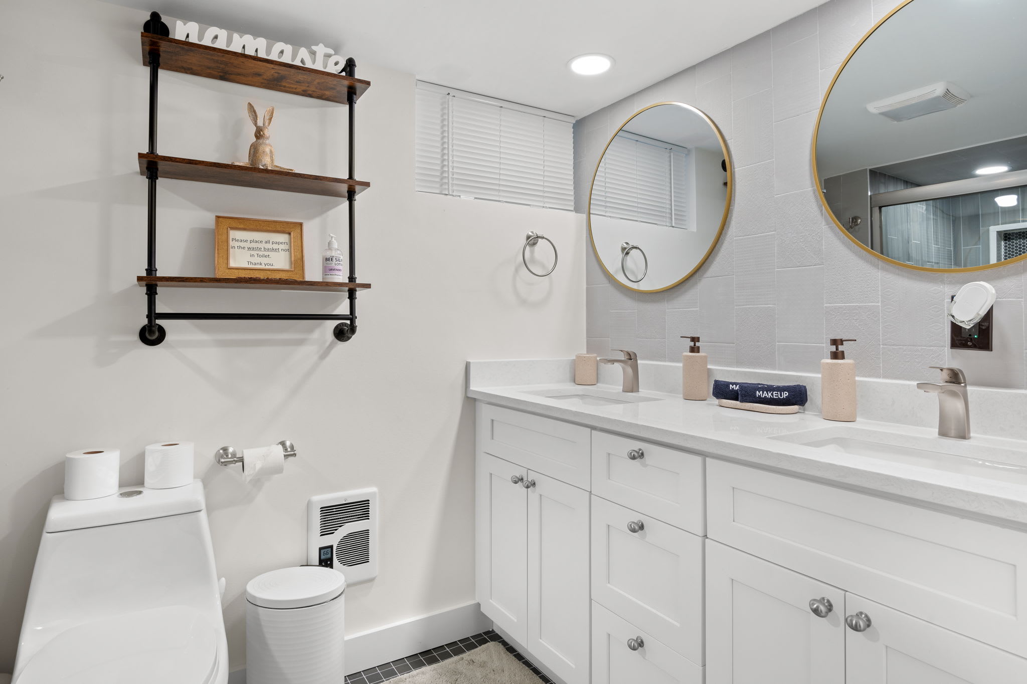 Step into your own private retreat. This modern bathroom offers double vanities, sleek finishes, and a refreshing rainfall shower.