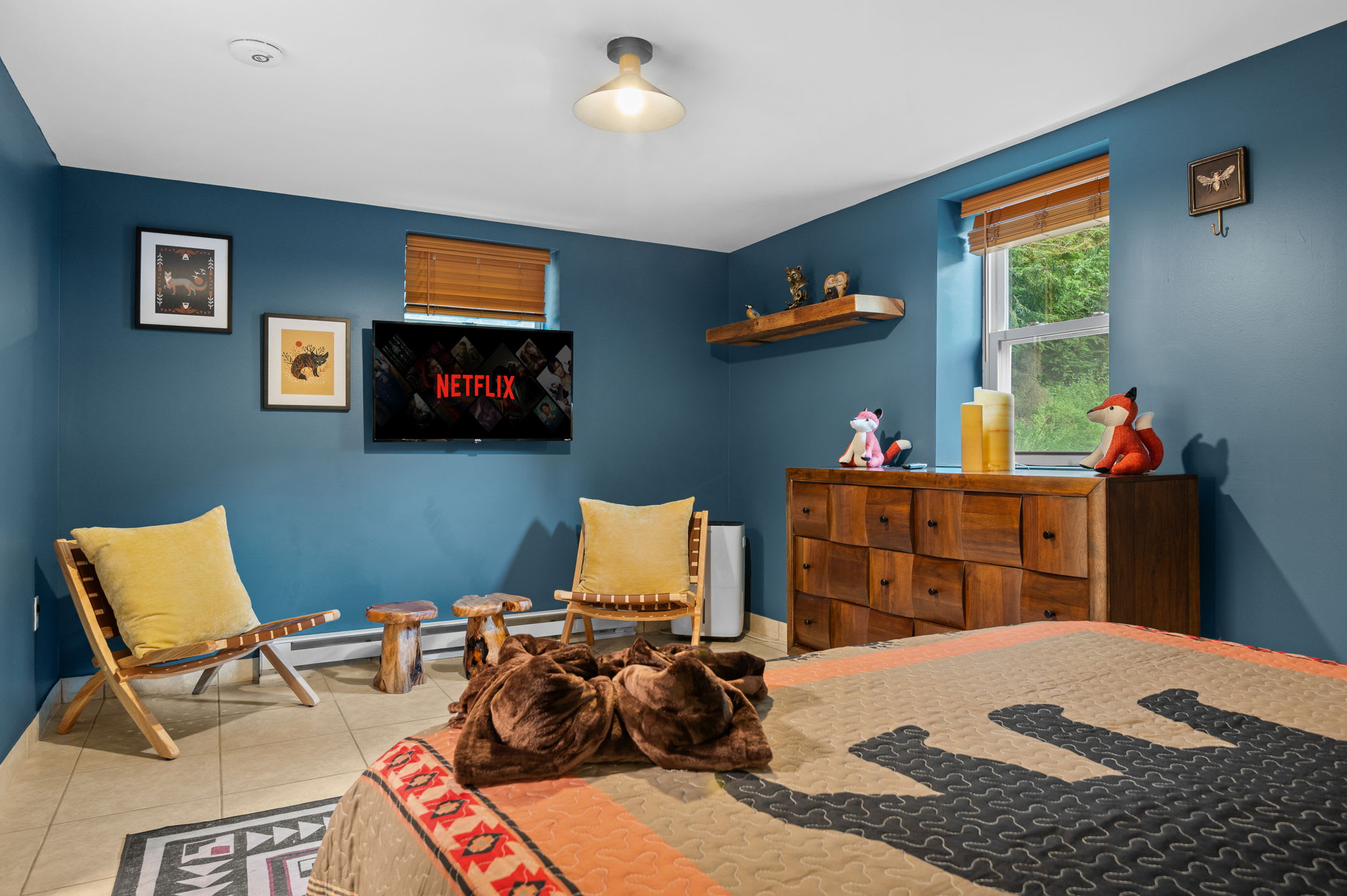 This bedroom offers a rustic charm with a modern touch, perfect for a peaceful night's sleep. Enjoy the cozy decor, soft lighting, and a welcoming ambiance.