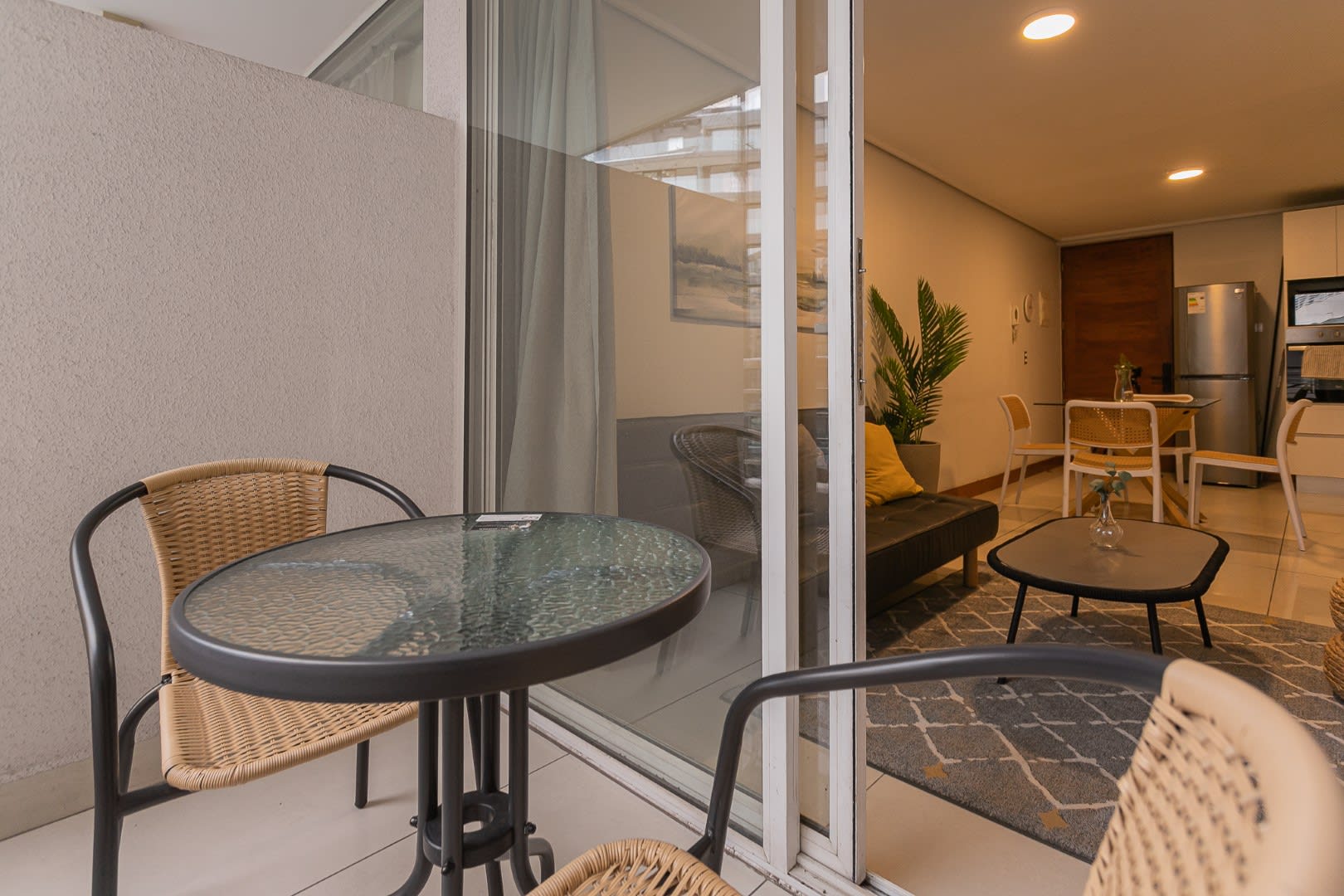 Cozy private patio perfect for relaxing, with easy access to a modern living area and kitchen.