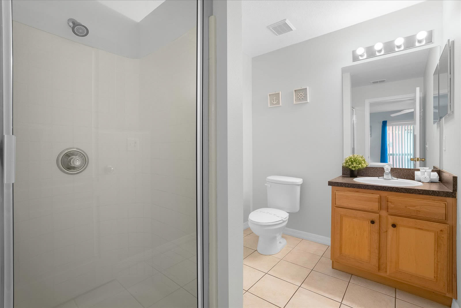 Bright Bathroom With A Shower And Modern Vanity