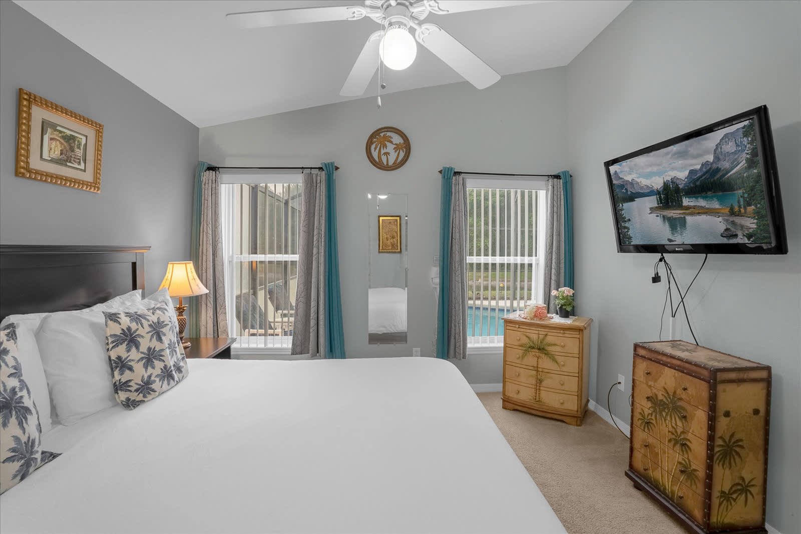 Bright Bedroom With A Queen-Size Bed, Smart TV, And Poolside Views