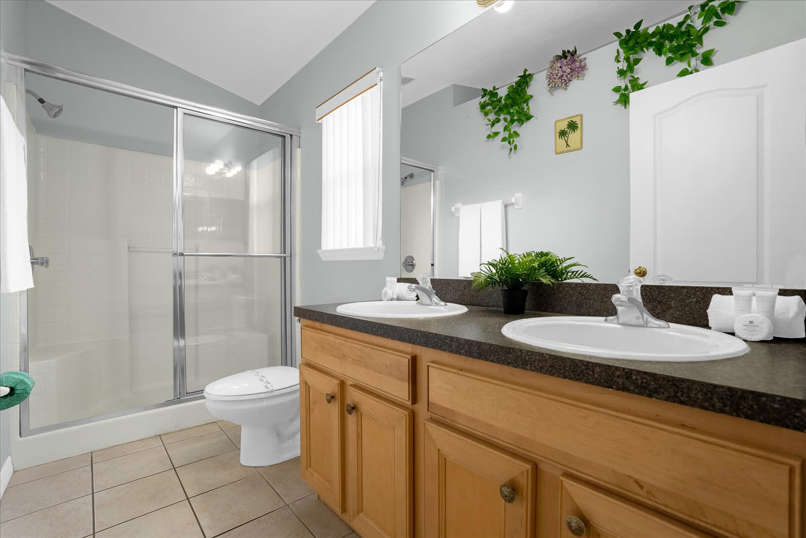 Spacious Bathroom With Double Sinks And A Shower