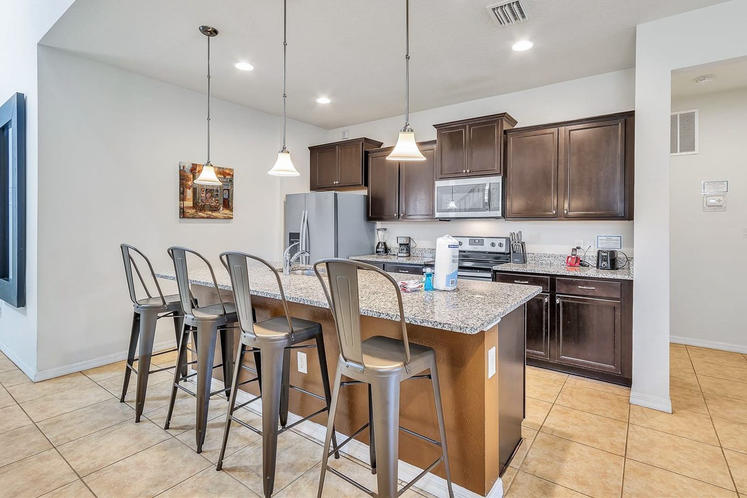 Fully Equipped Kitchen with Centered Island and Bar Stools