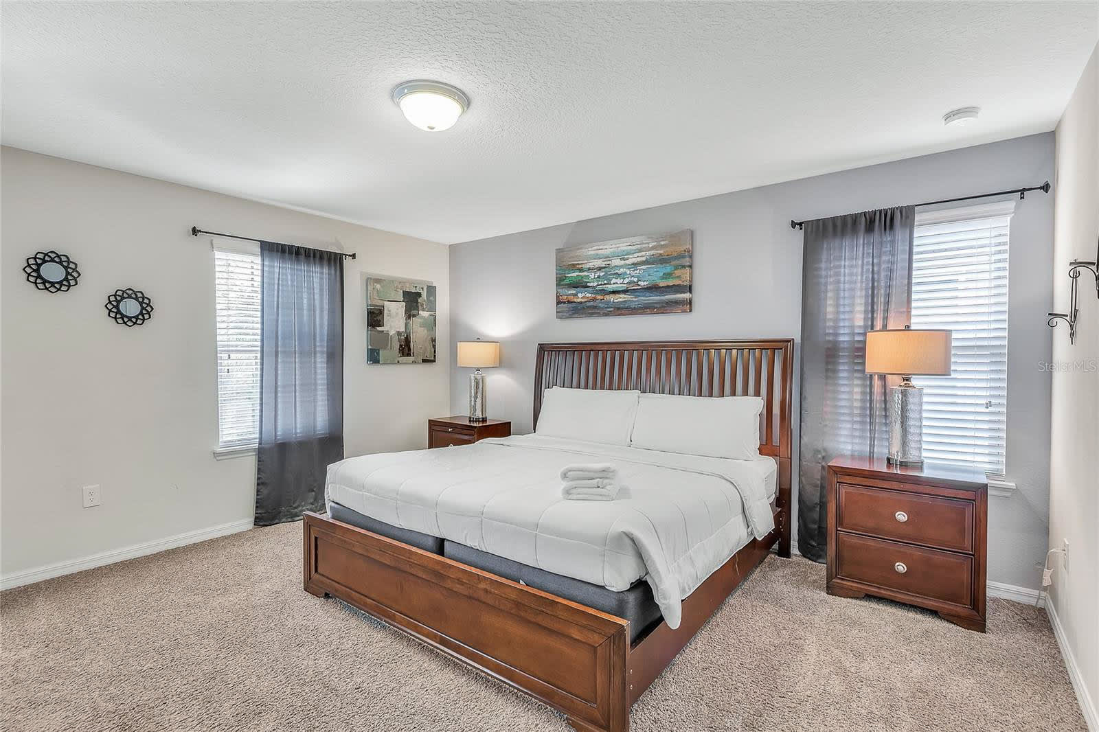 Rest Comfortably In This Bright Bedroom With Elegant Wooden Furniture