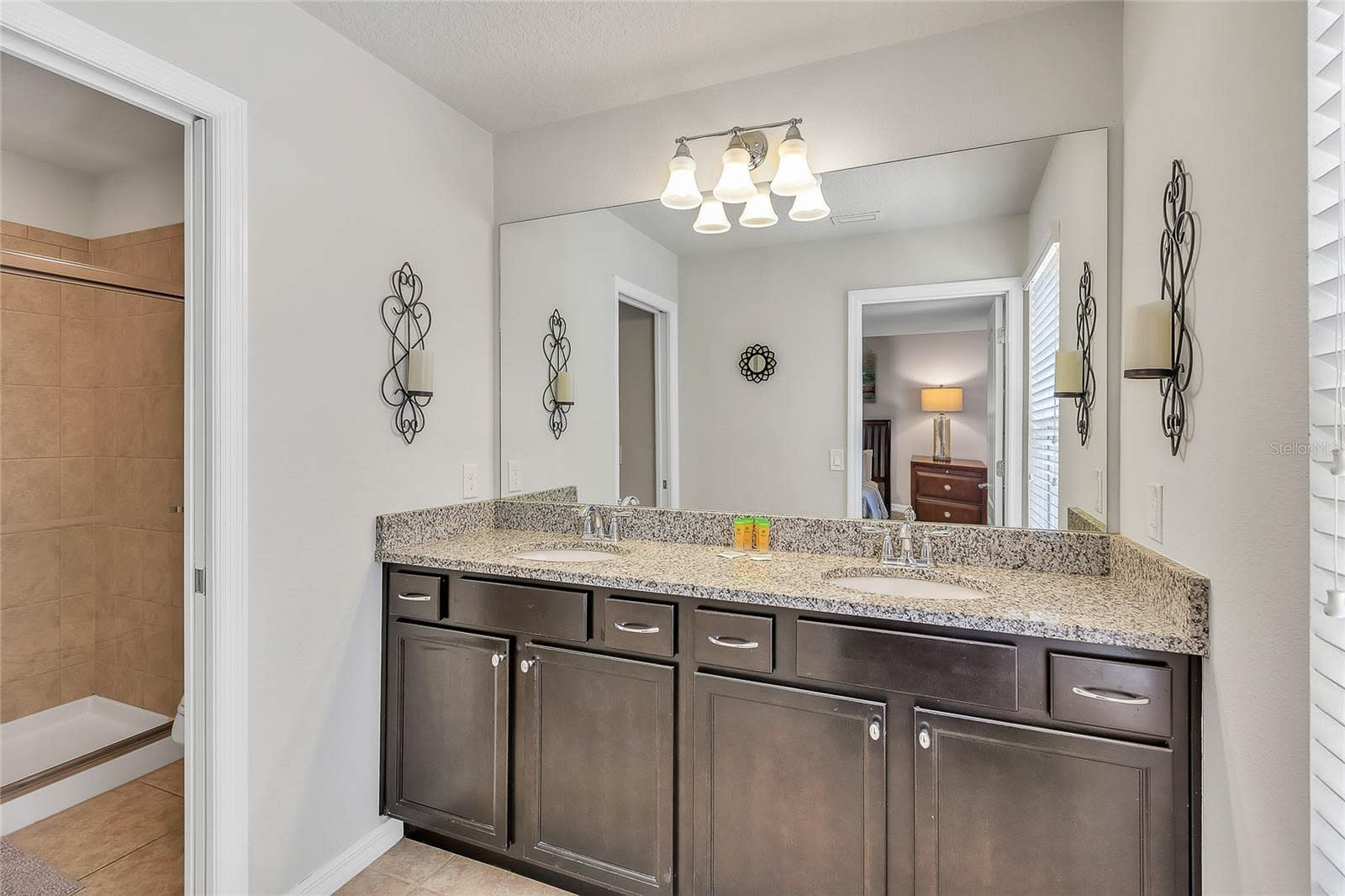 Refresh In This Modern Bathroom Featuring A Granite Countertop