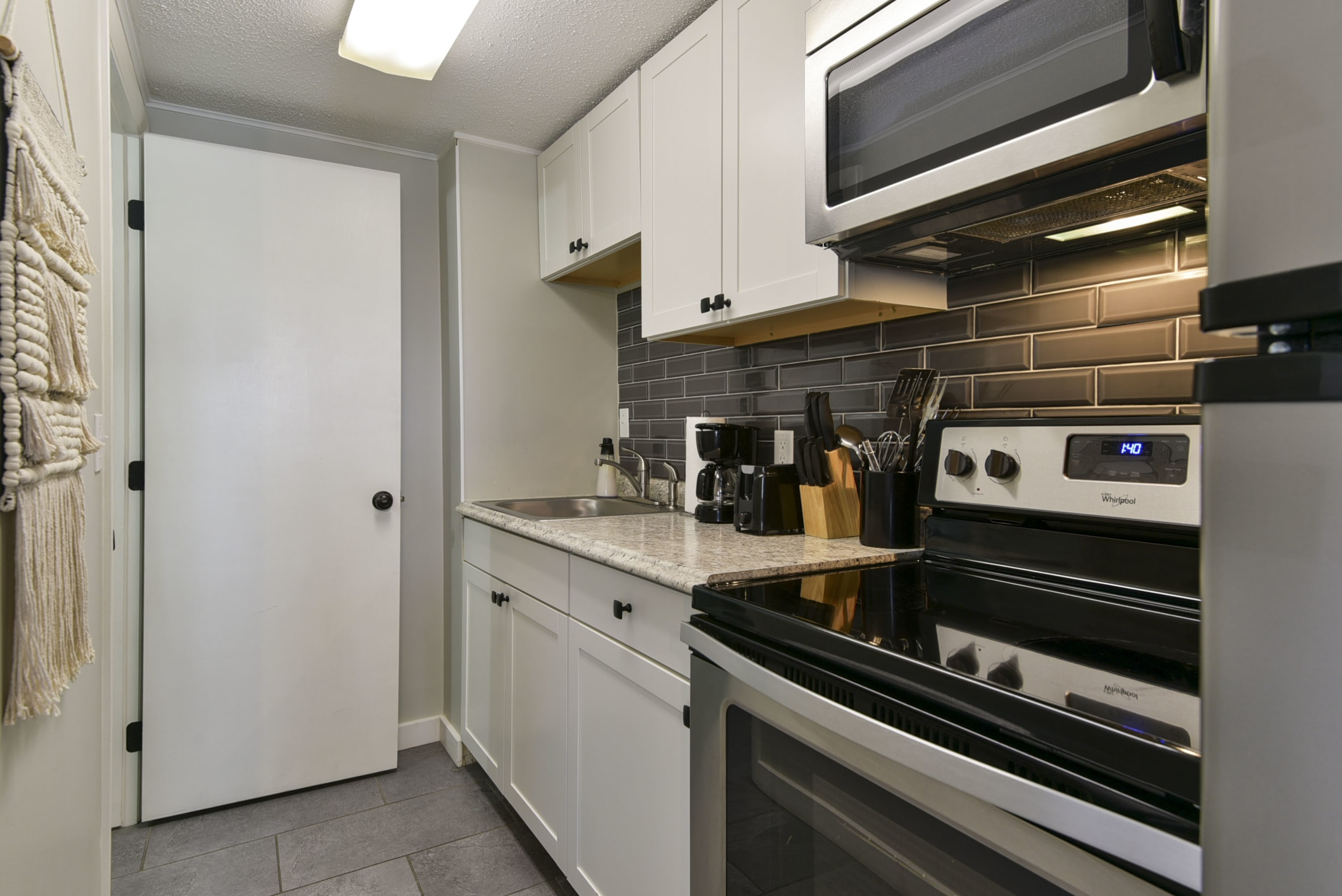 Kitchen with a view of the doorway to the bathroom
