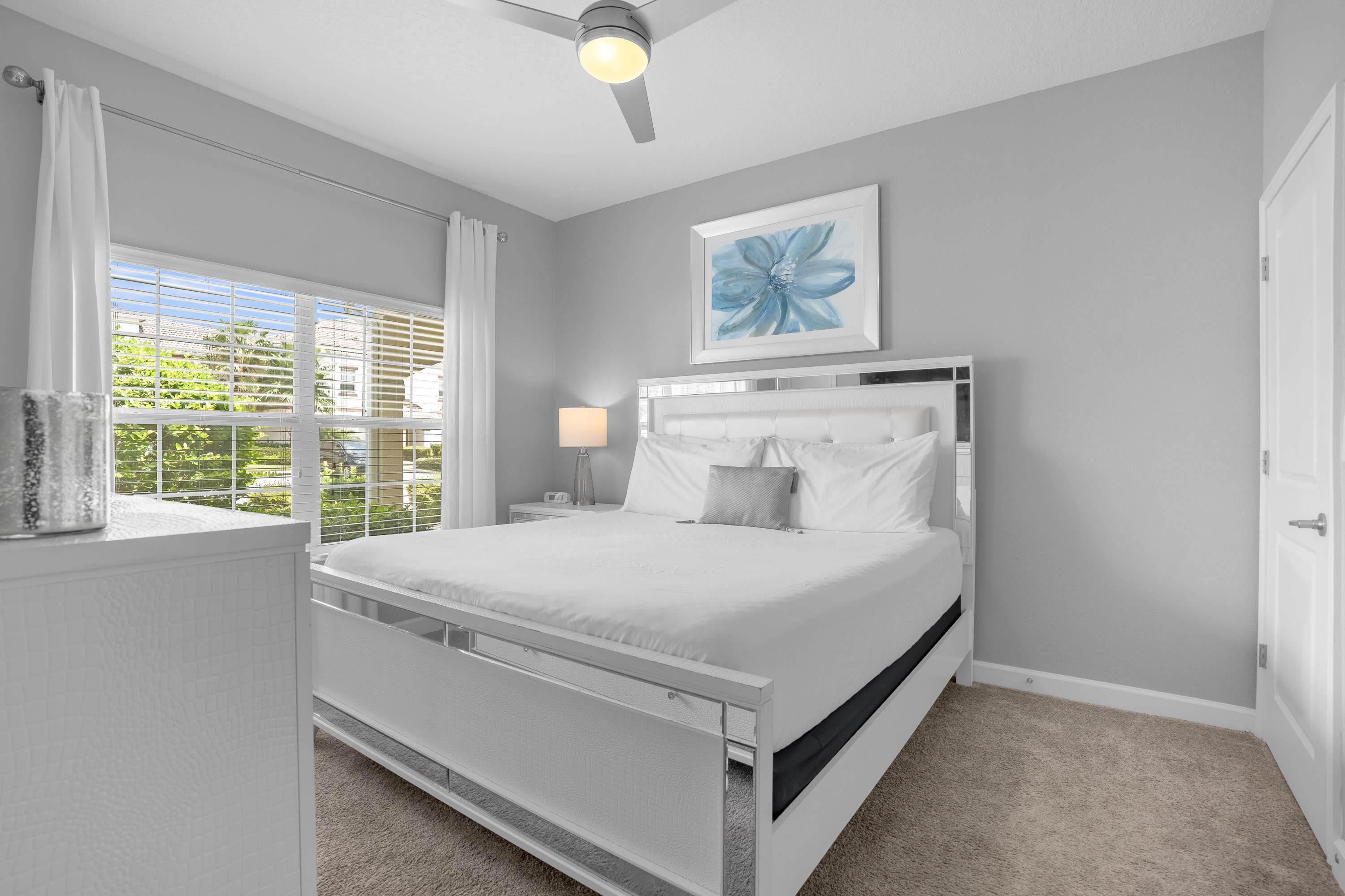 Bright And Airy Bedroom With A Comfortable Queen Bed