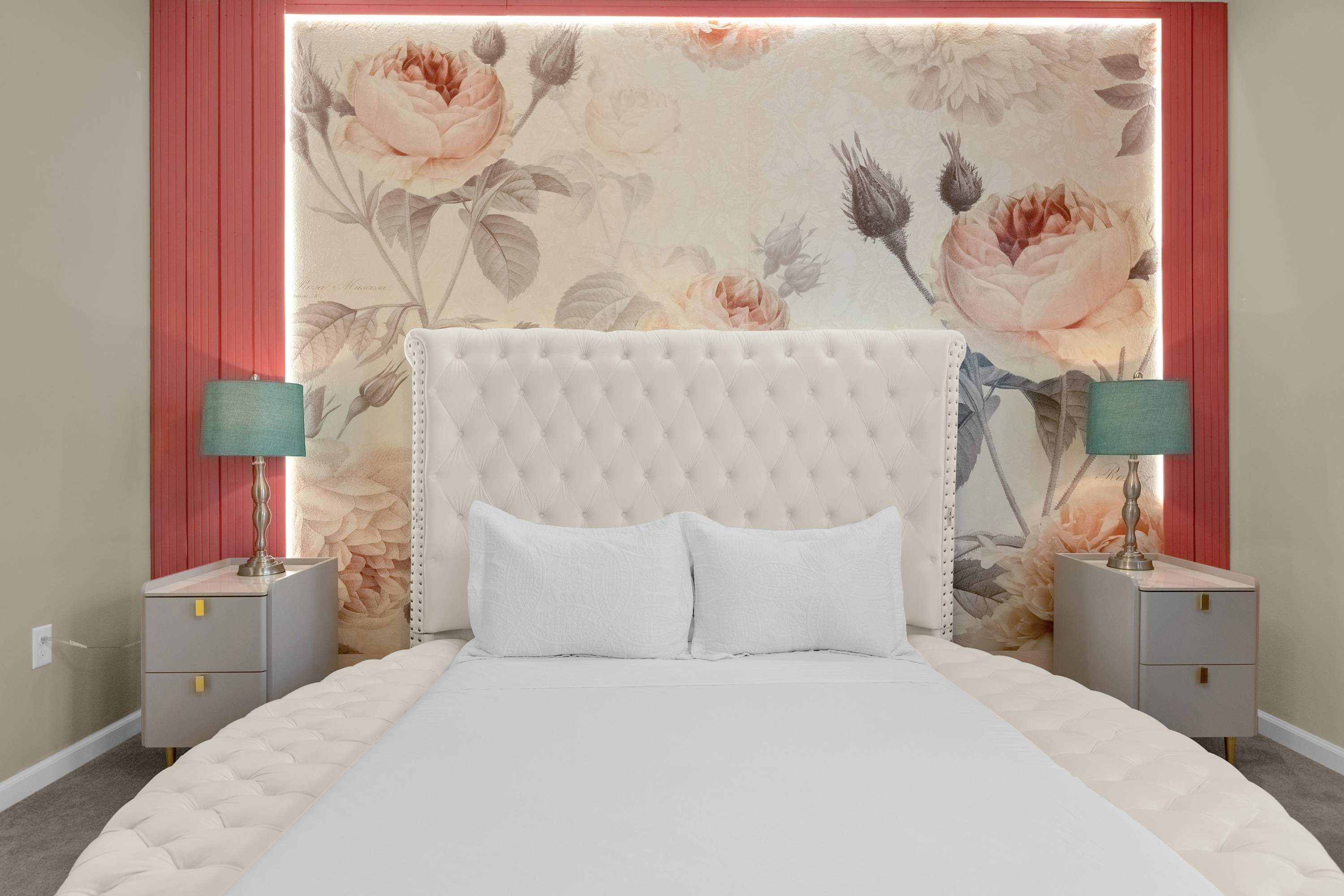 Elegant Bedroom With A Queen Bed, Colorful Wall Decor, And A Smart TV