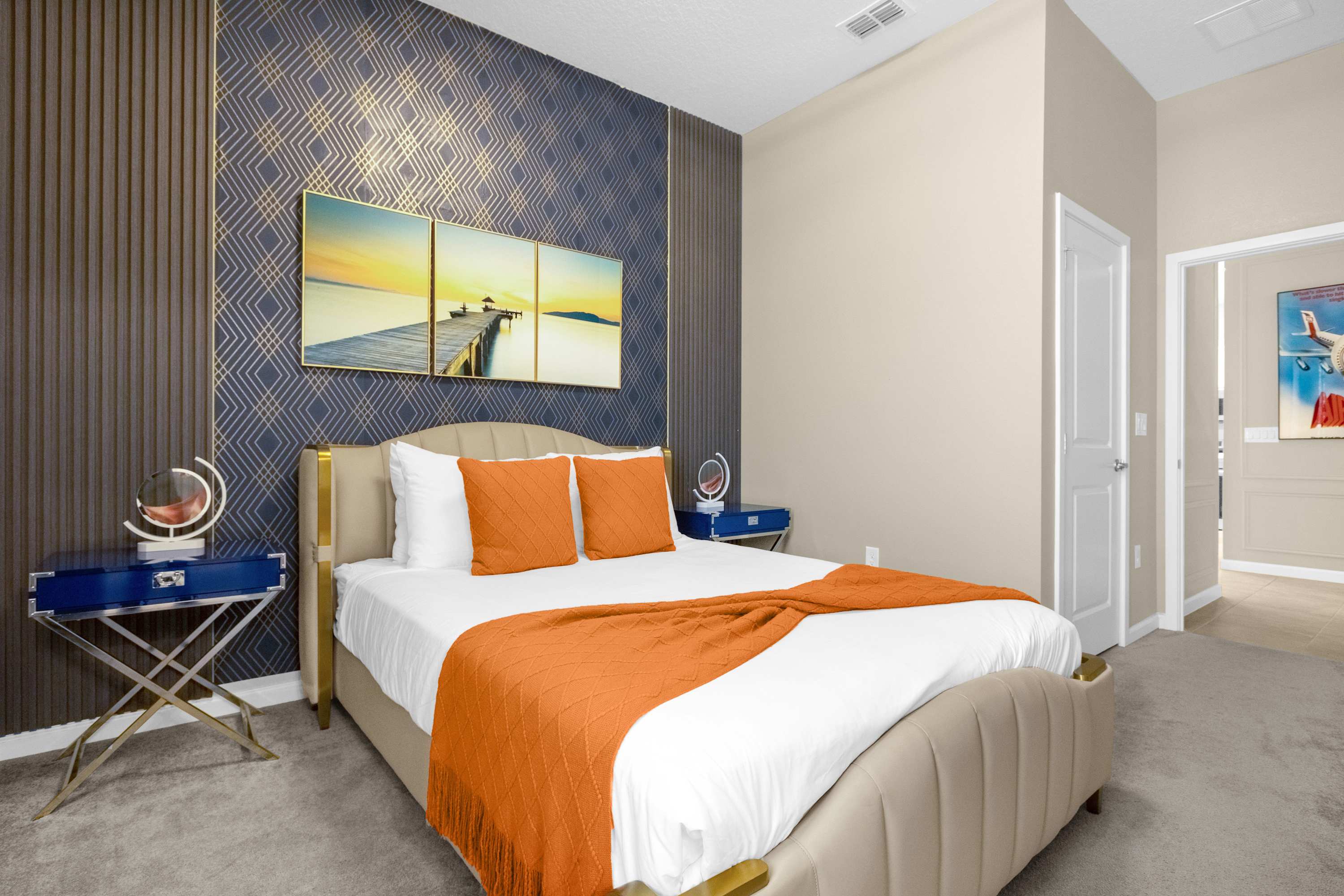 Elegant Bedroom With A Queen Bed, Colorful Wall Decor, And A Smart TV