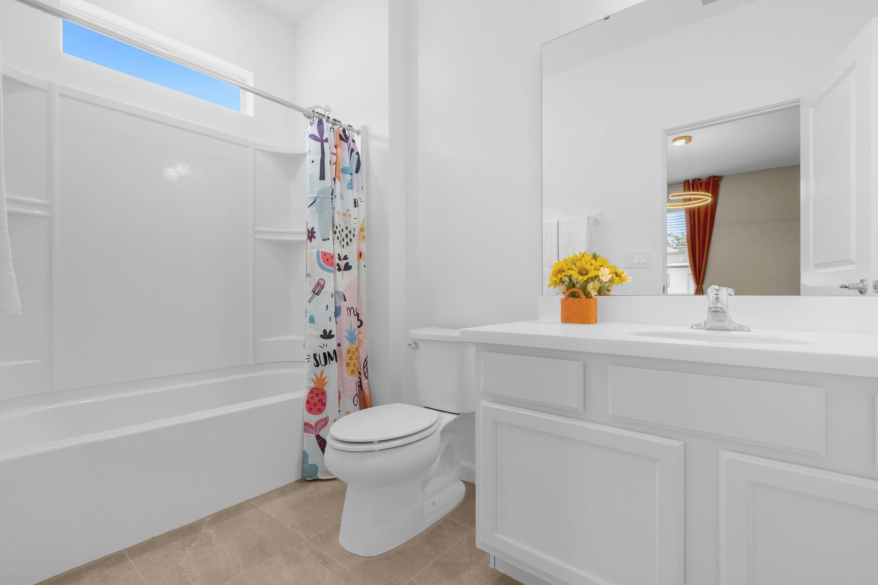 Bright Bathroom With Playful Shower Curtain And Elegant Vanity