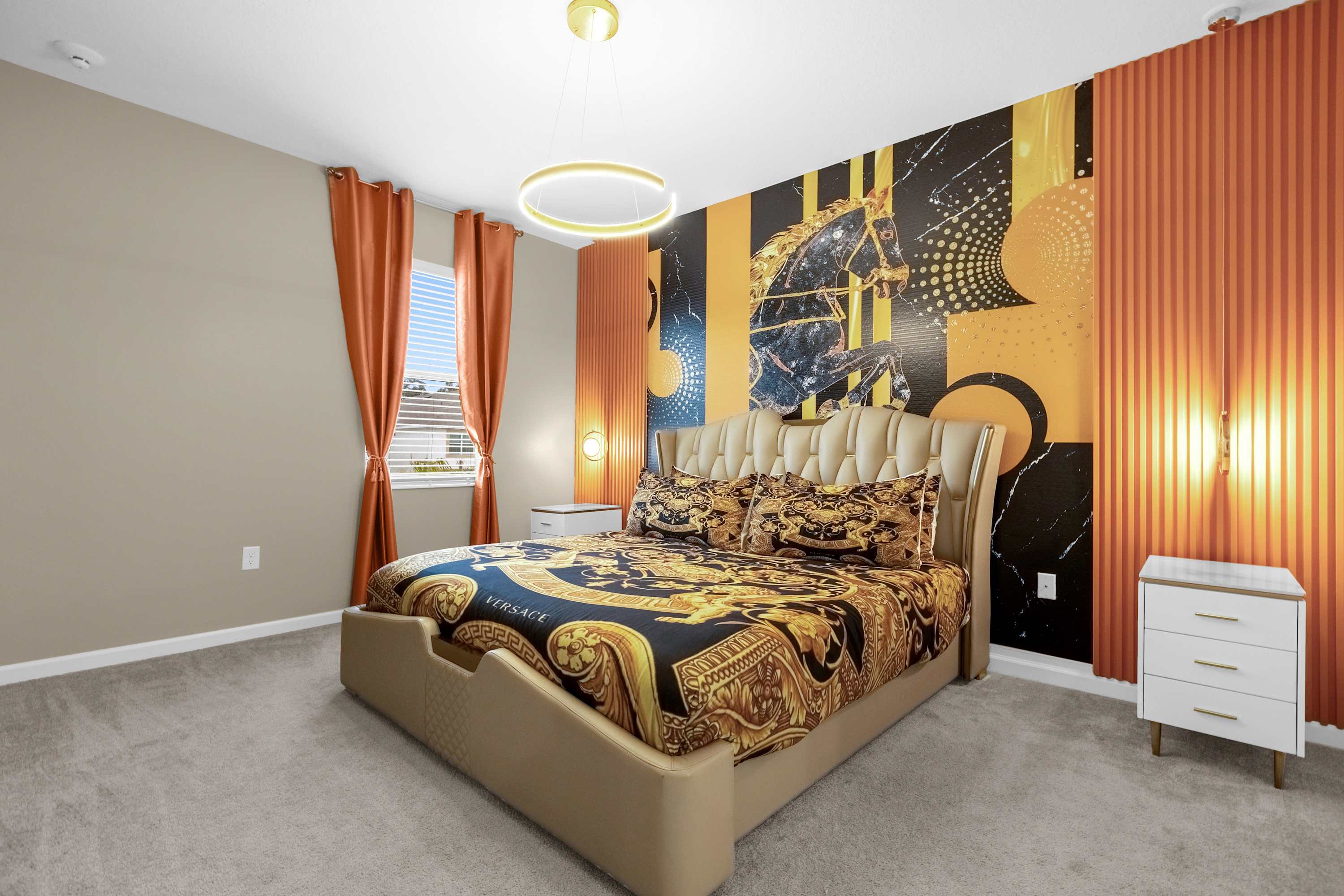 Elegant Bedroom With A Queen Bed, Colorful Wall Decor, And A Smart TV