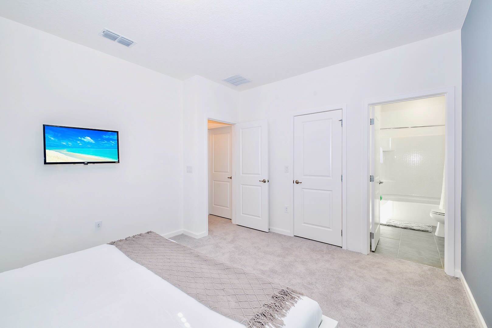Elegant Bedroom With King Bed And Wall-Mounted Smart TV